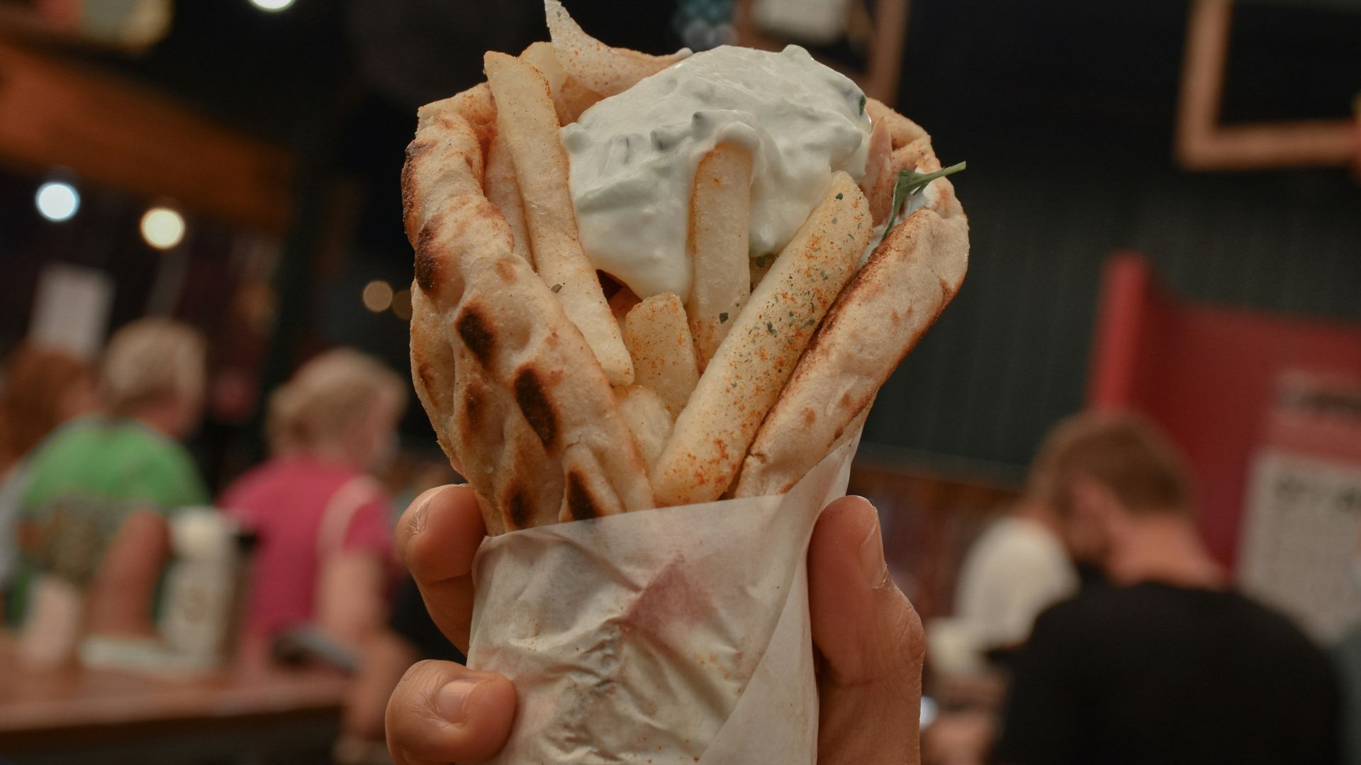 a person holding a bag of food in their hand