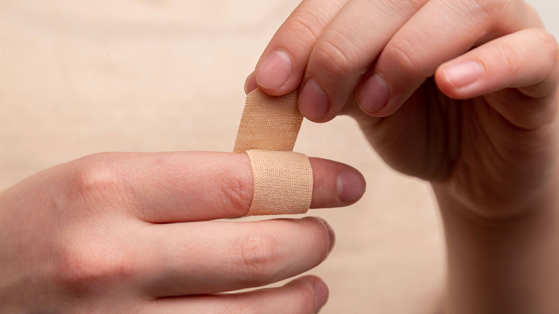 person with band aid on middle finger