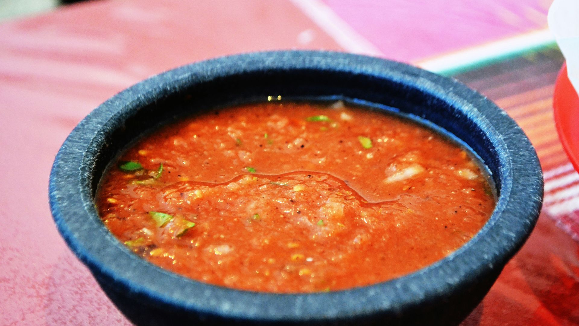 a bowl of soup sitting on top of a table