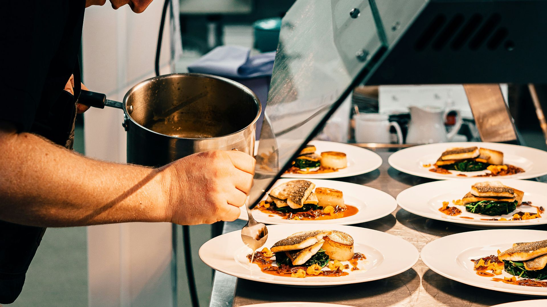 man in black t-shirt holding stainless steel bowl