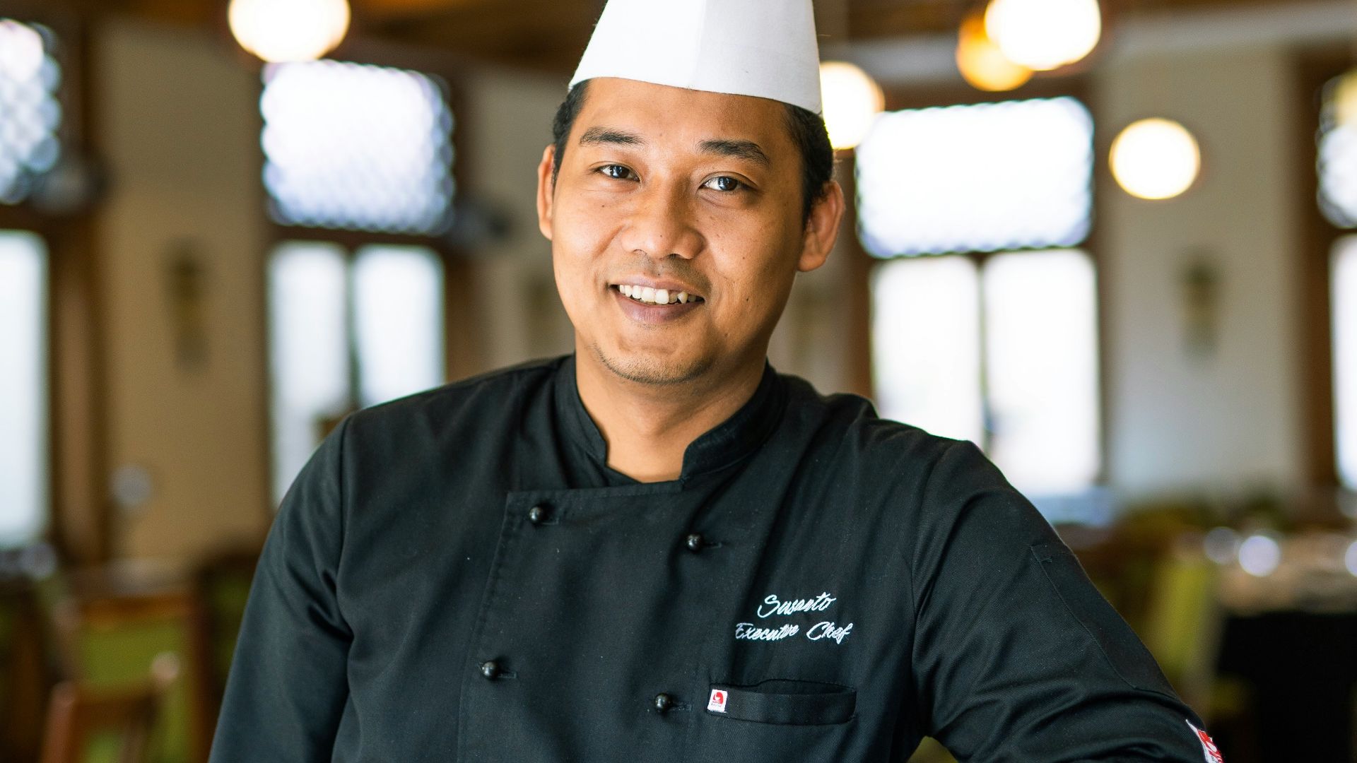 man in black nike jacket wearing white cap