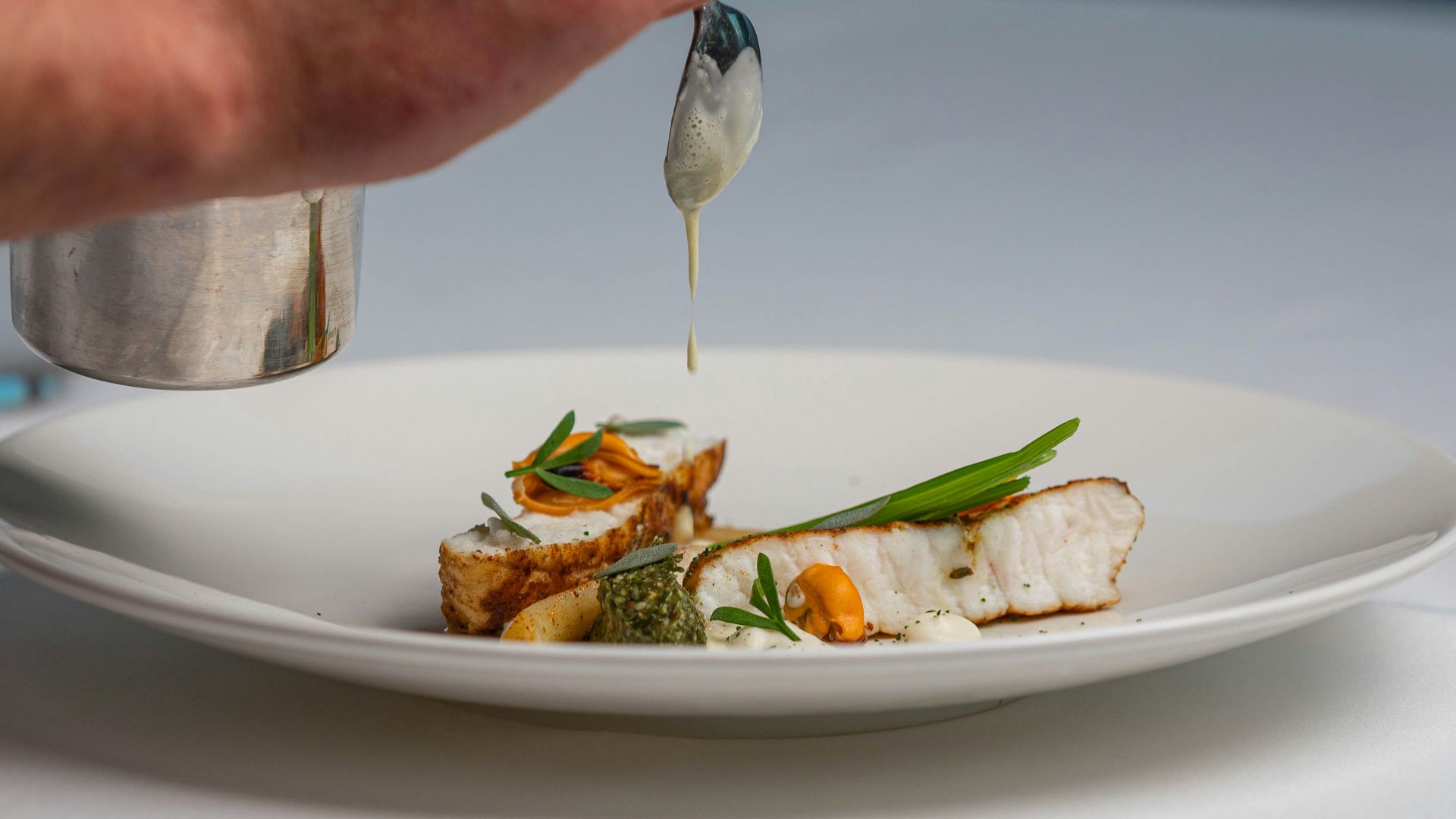 a white plate topped with fish and vegetables