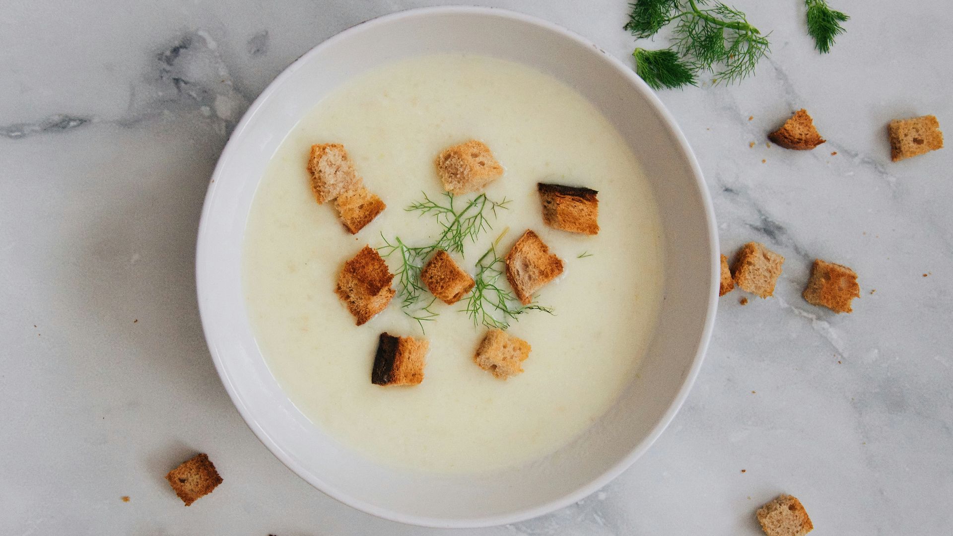soup with green leaf on white ceramic bowl