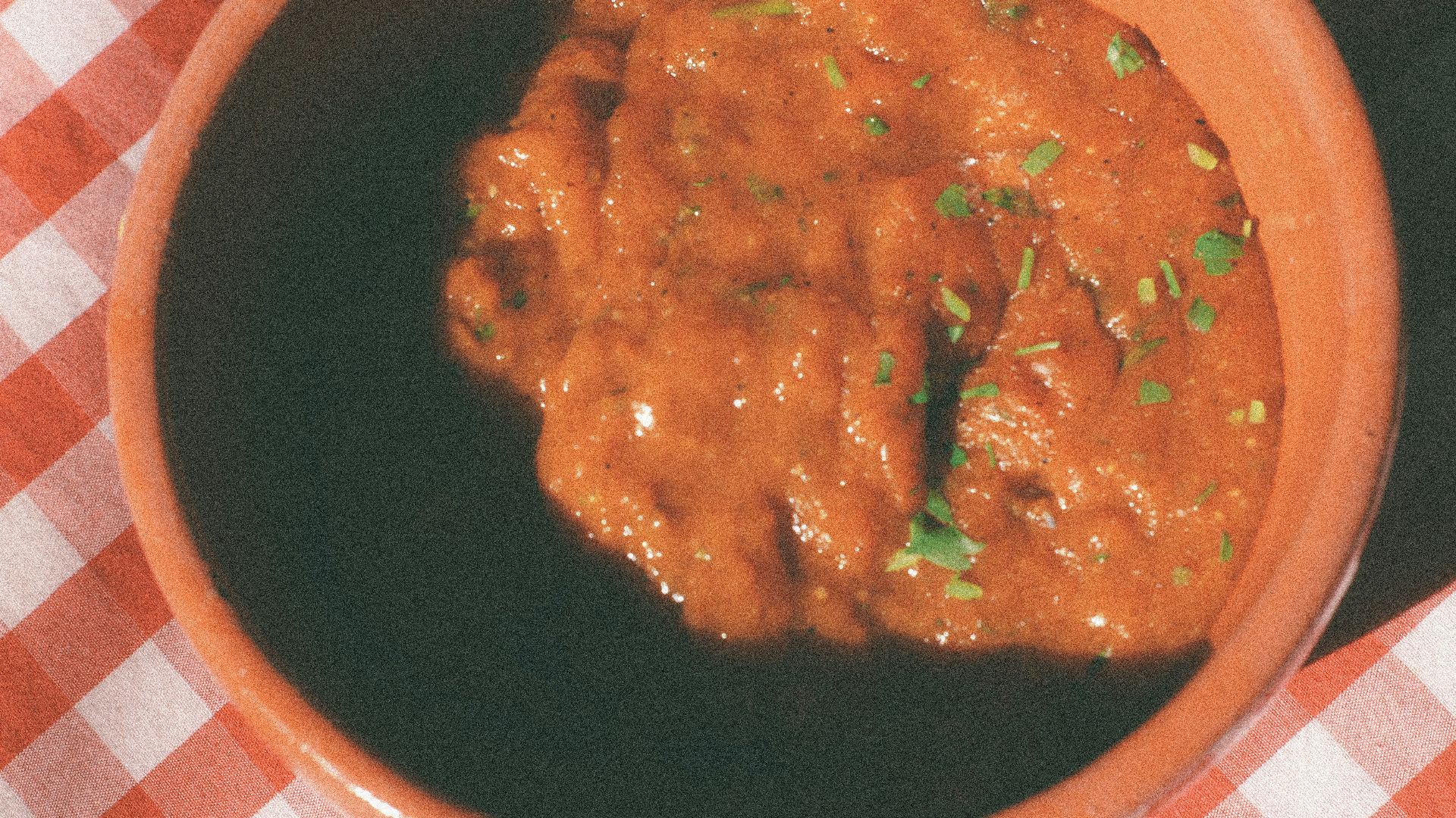 cooked food on red and white checkered plate