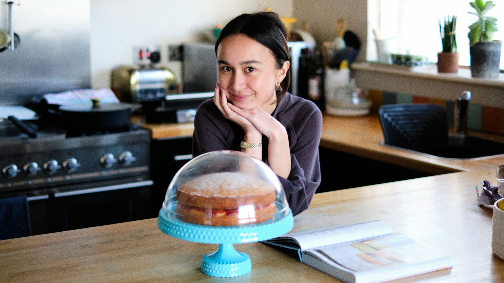 woman in pink long sleeve shirt sitting at the table