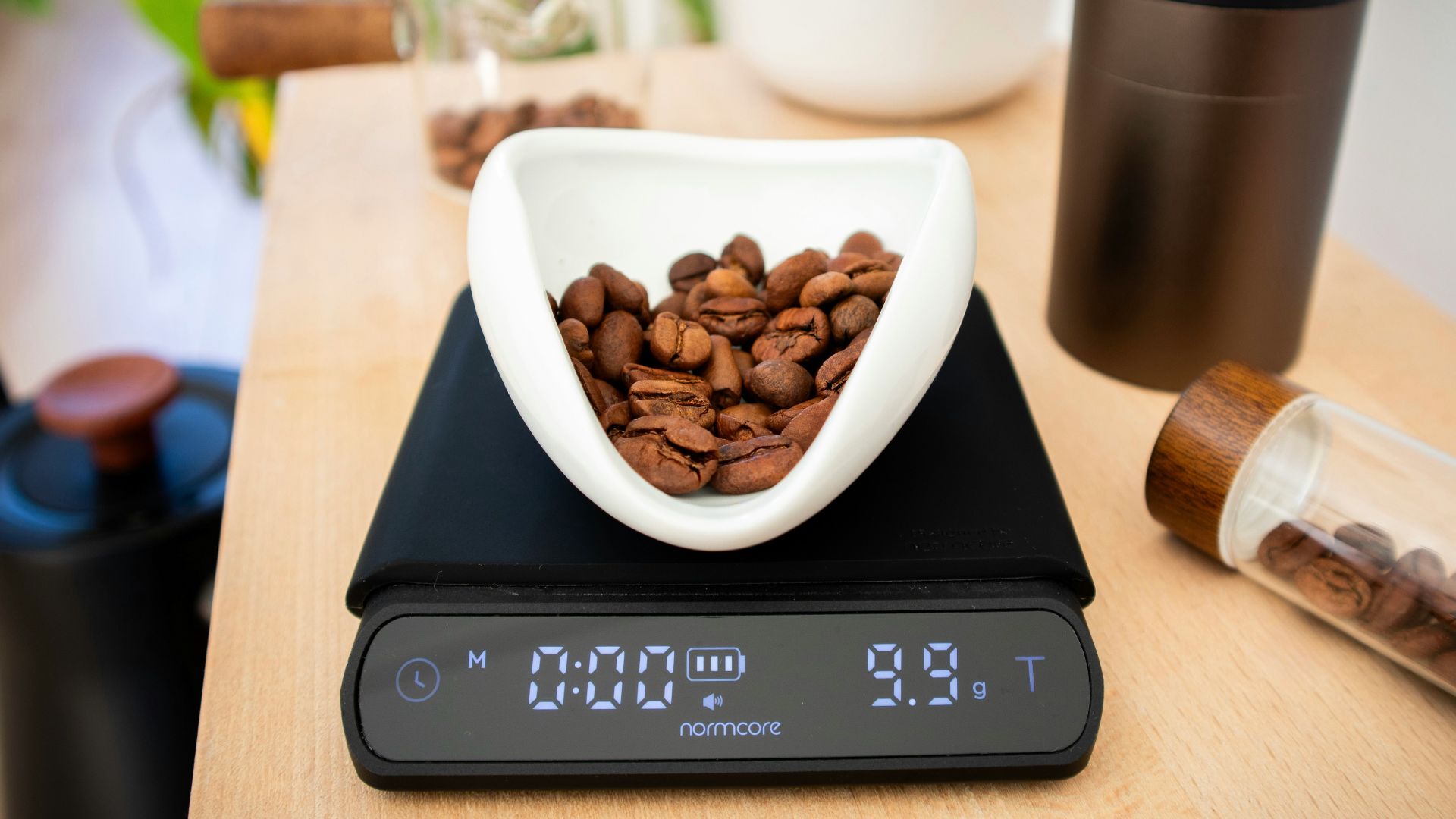 Coffee beans are being weighed on a digital scale.