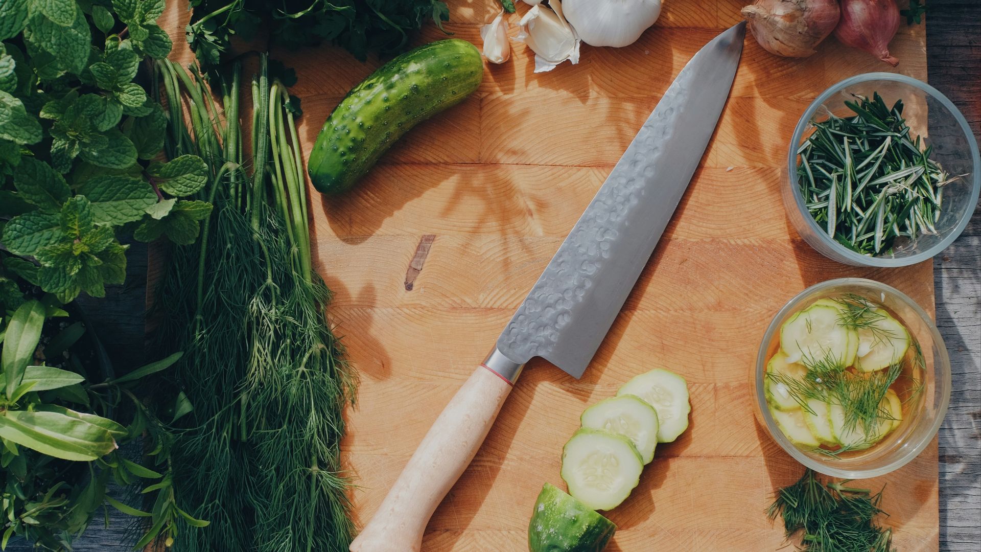 sliced cucumber and green vegetable on brown wooden table