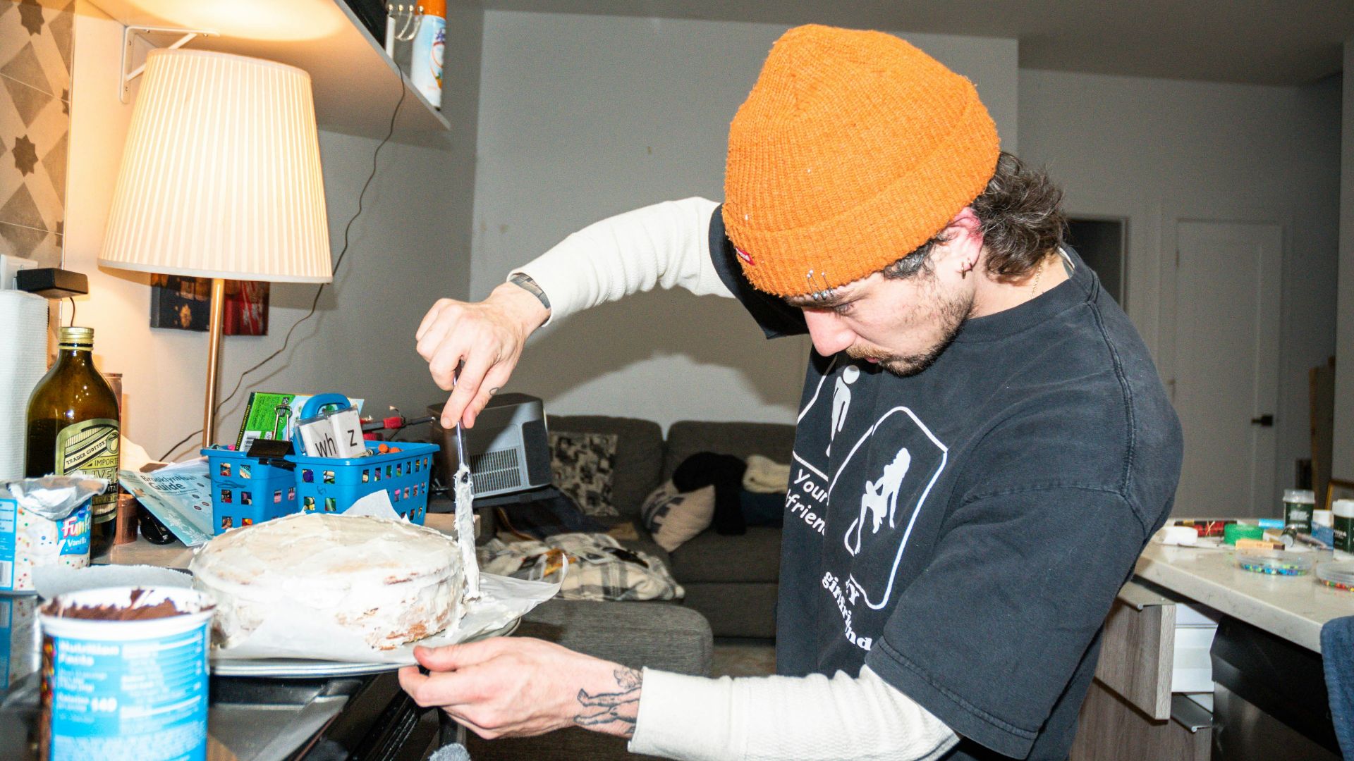 a man cutting a cake with a knife