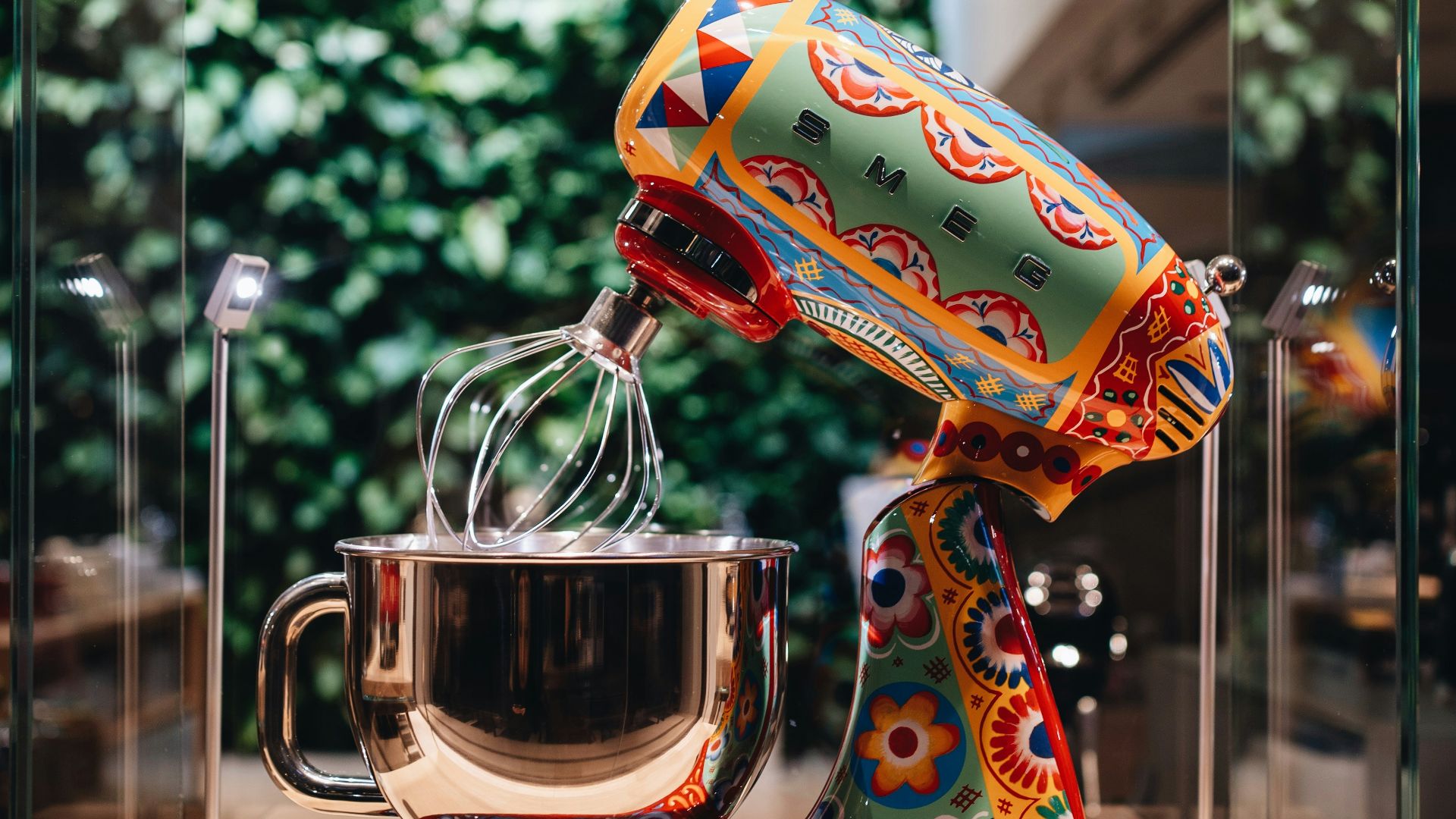 multicolored stand mixer with glass case