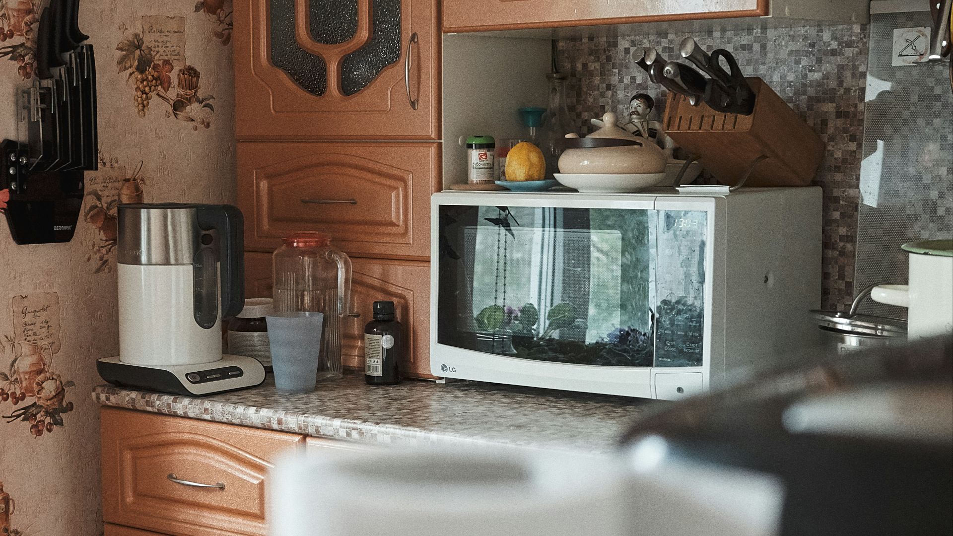 white microwave oven on brown wooden cabinet