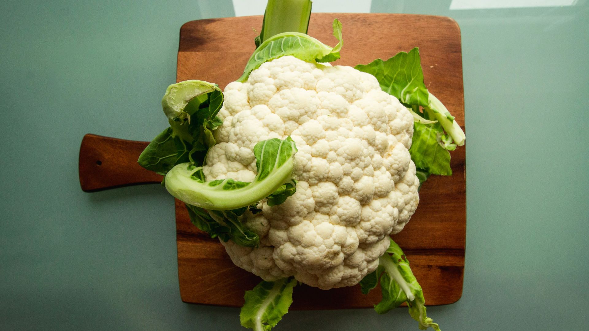 white cauliflower on brown wooden chopping board