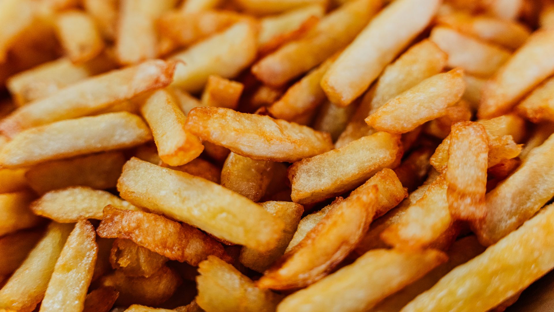 a pile of french fries sitting on top of a table