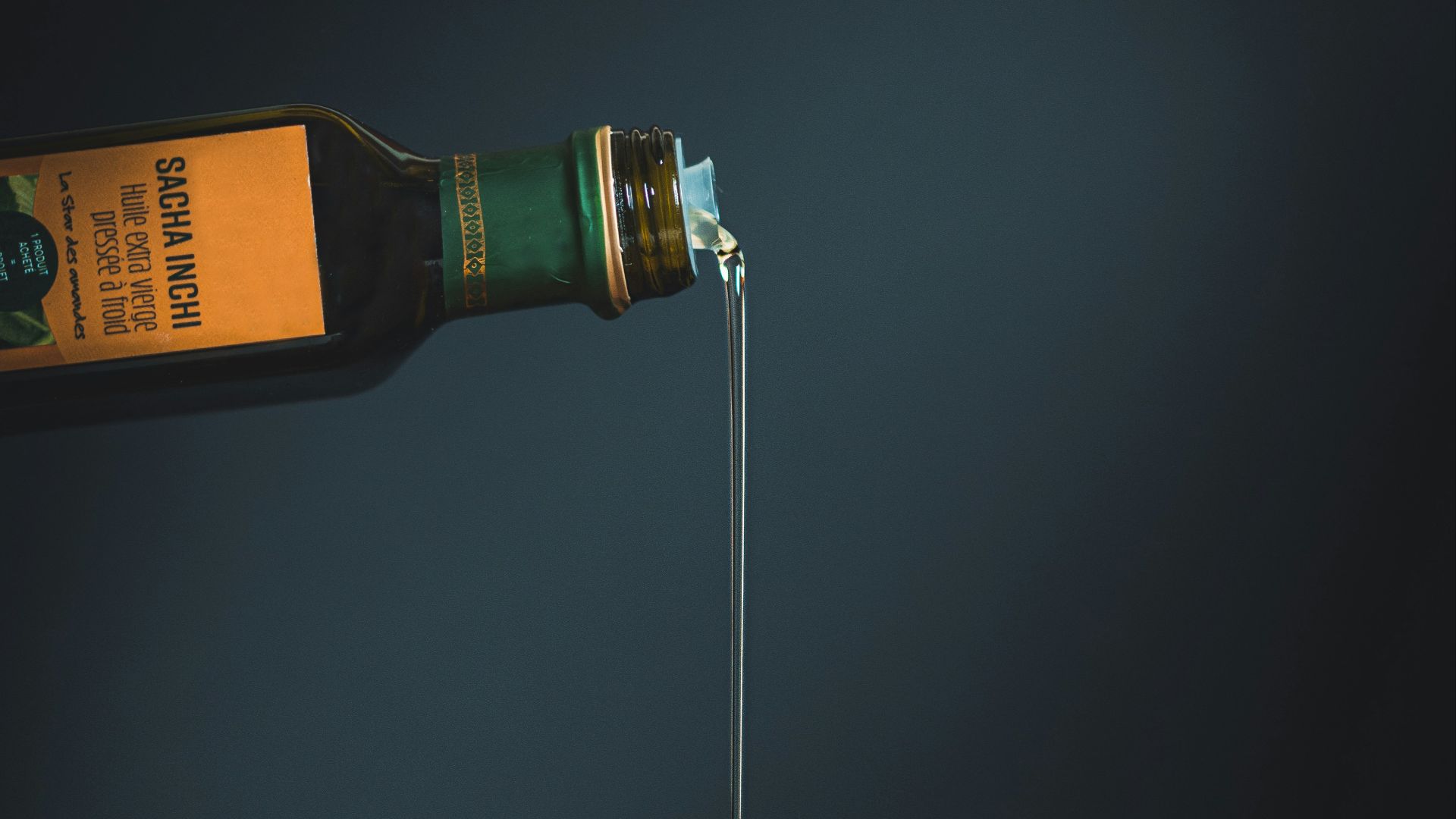 bottle with white liquid pouring through the brown slab
