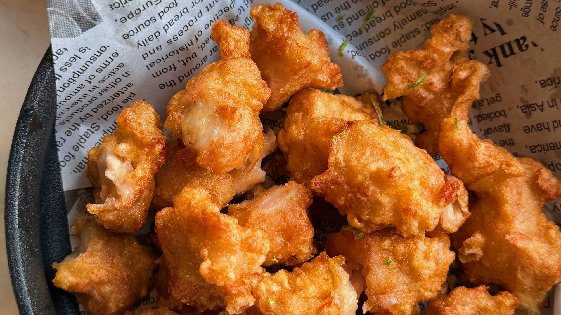a bowl of fried food next to a bowl of mayonnaise