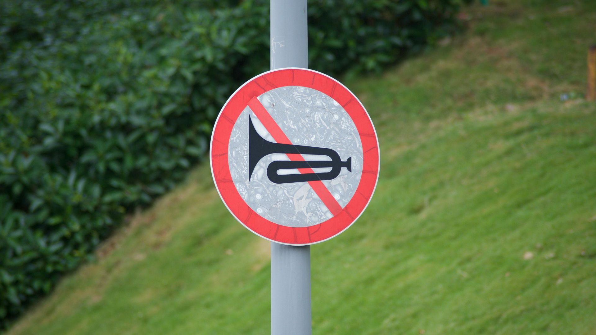 a red and white sign that is on a pole