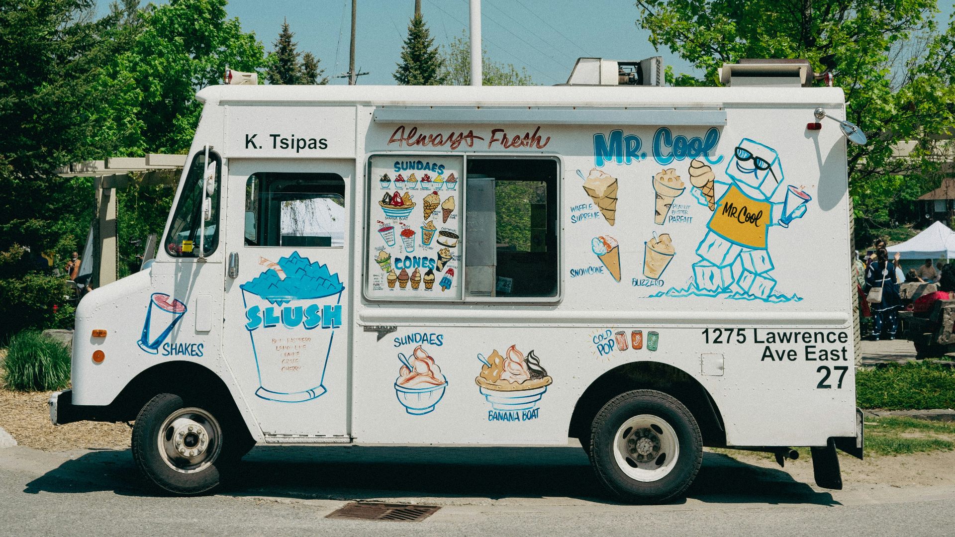 a food truck with a canadian flag on top of it