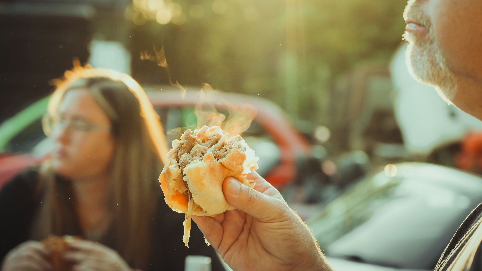a man holding a hot dog in his hand