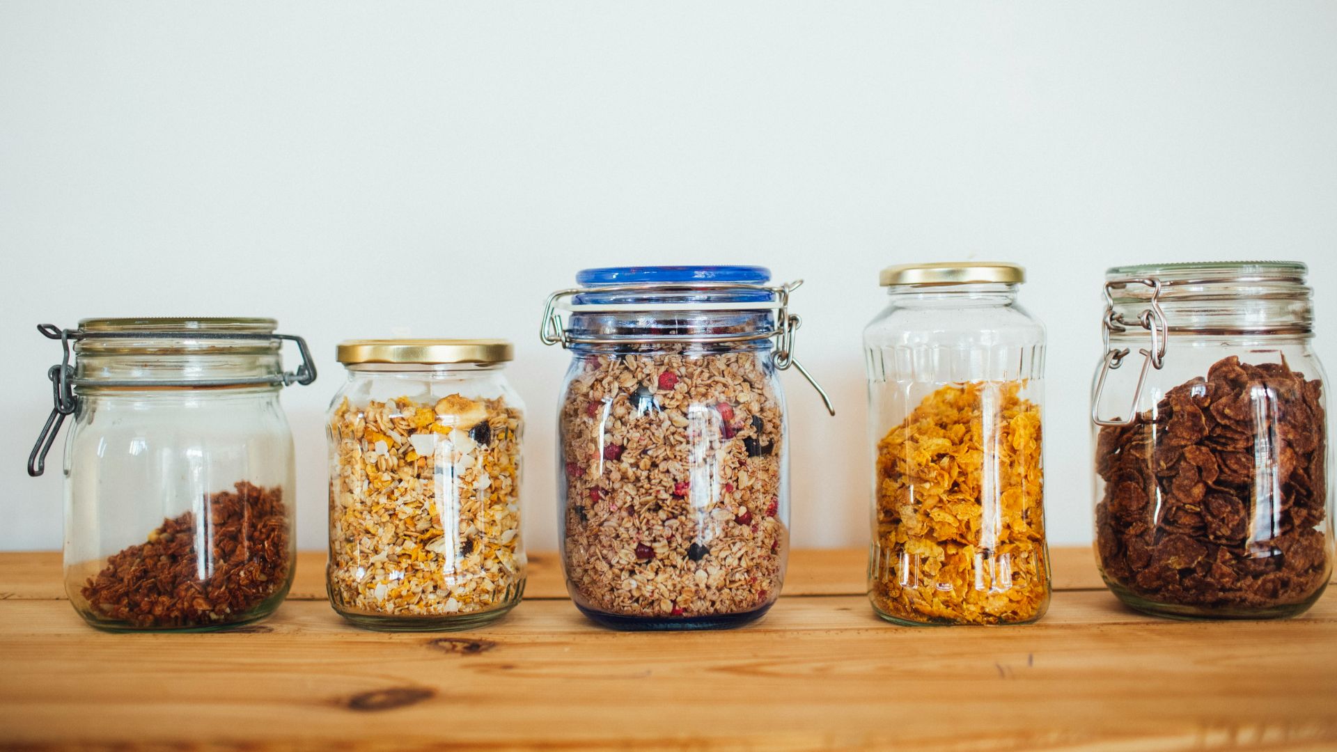 two clear glass jars with brown and black beads