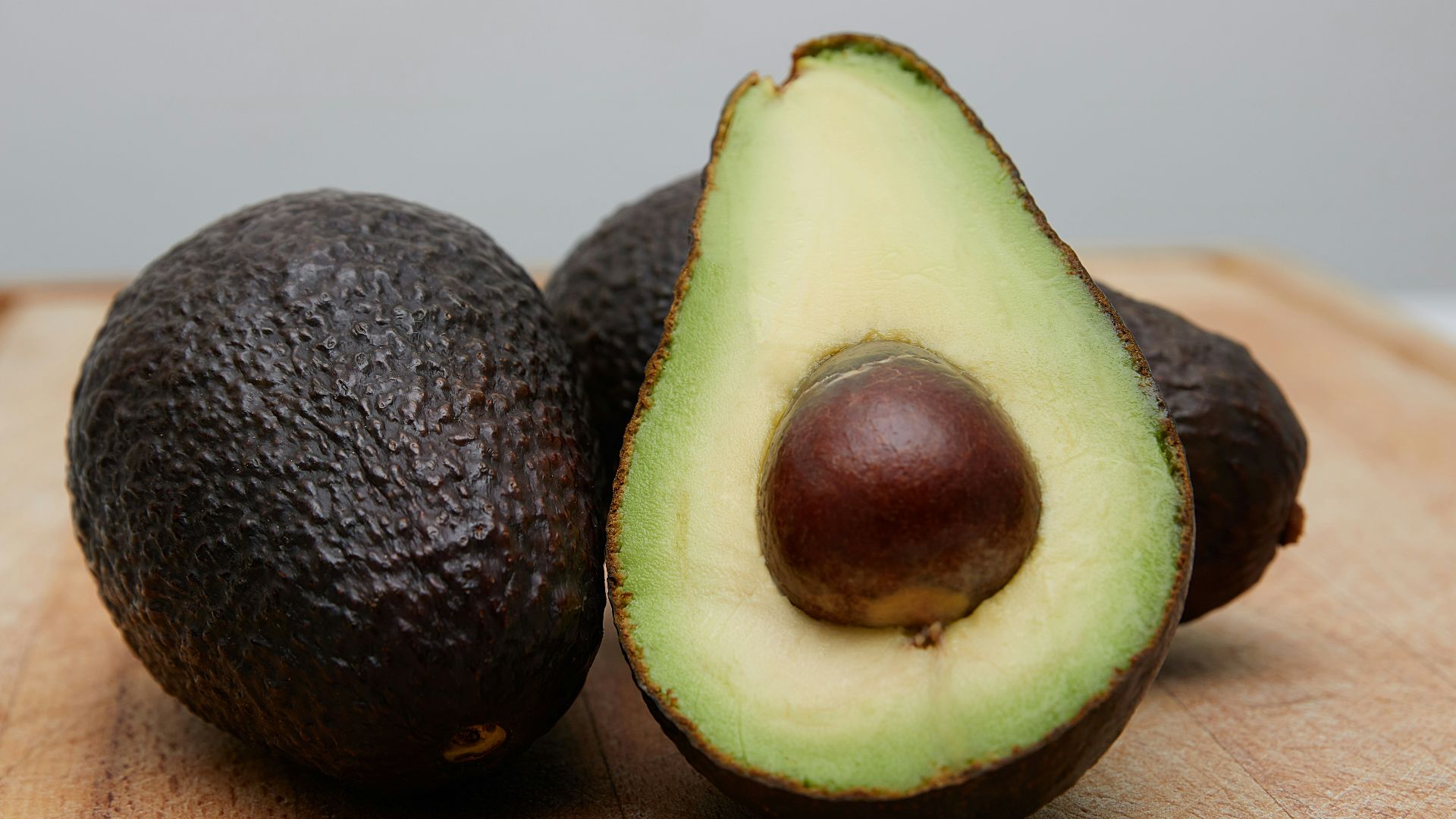 sliced avocado fruit on brown wooden table