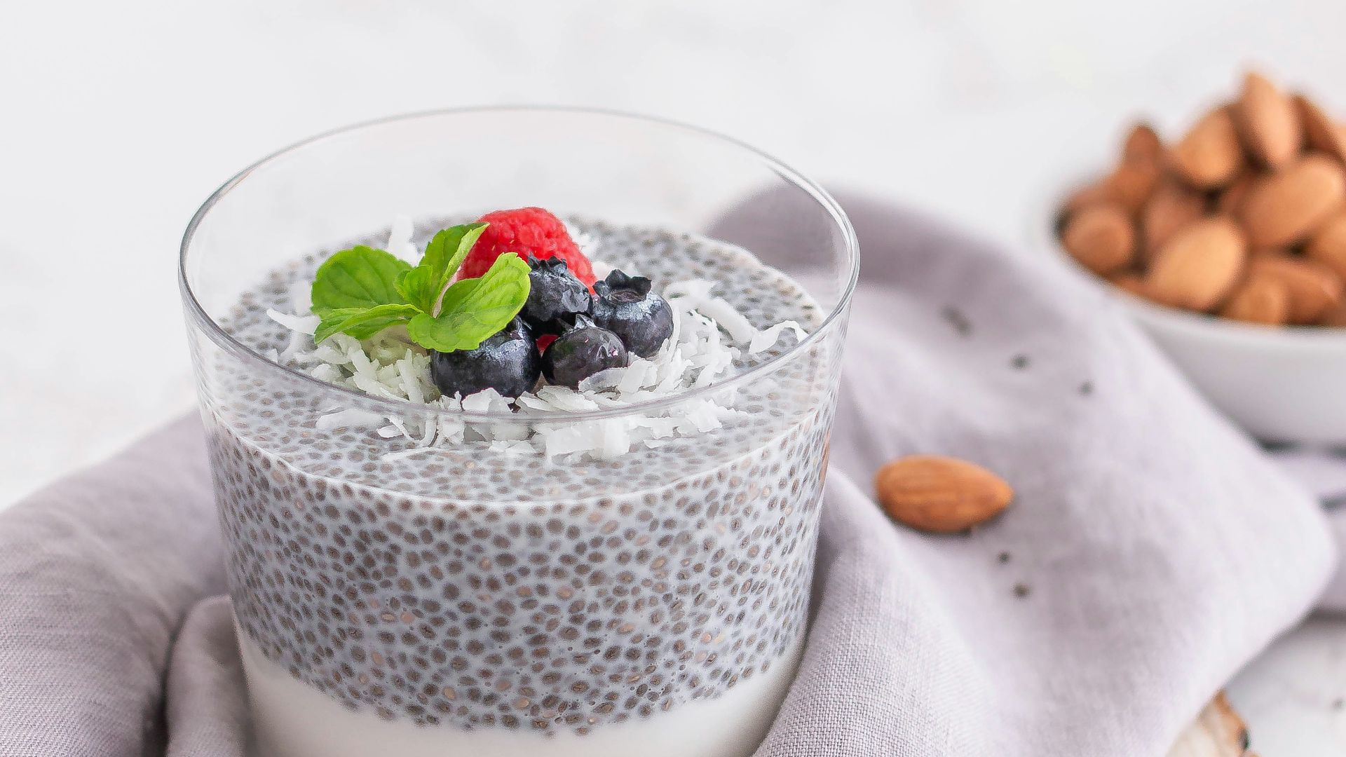 a glass of milk with berries and a spoon