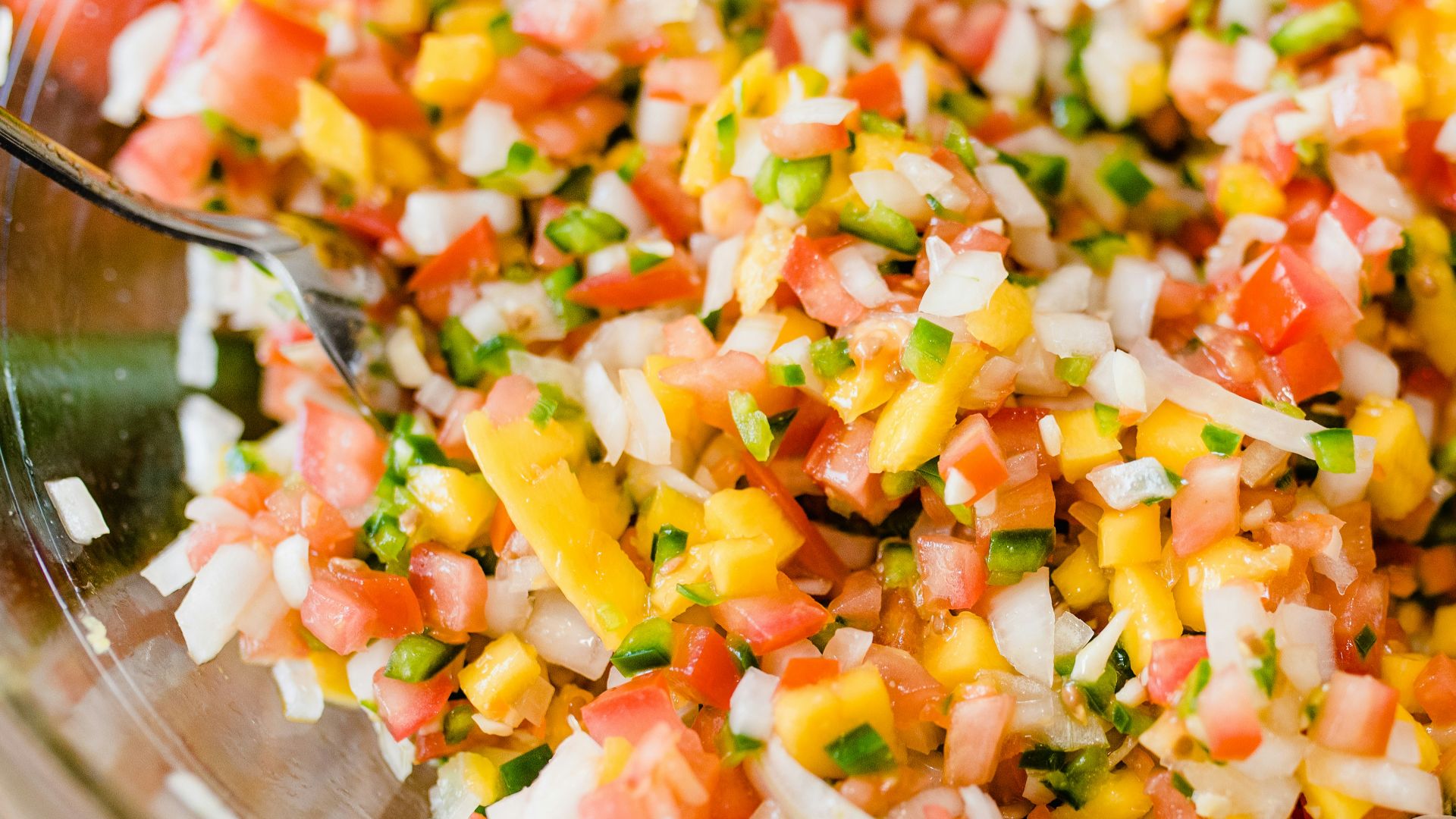 a glass bowl filled with chopped up vegetables