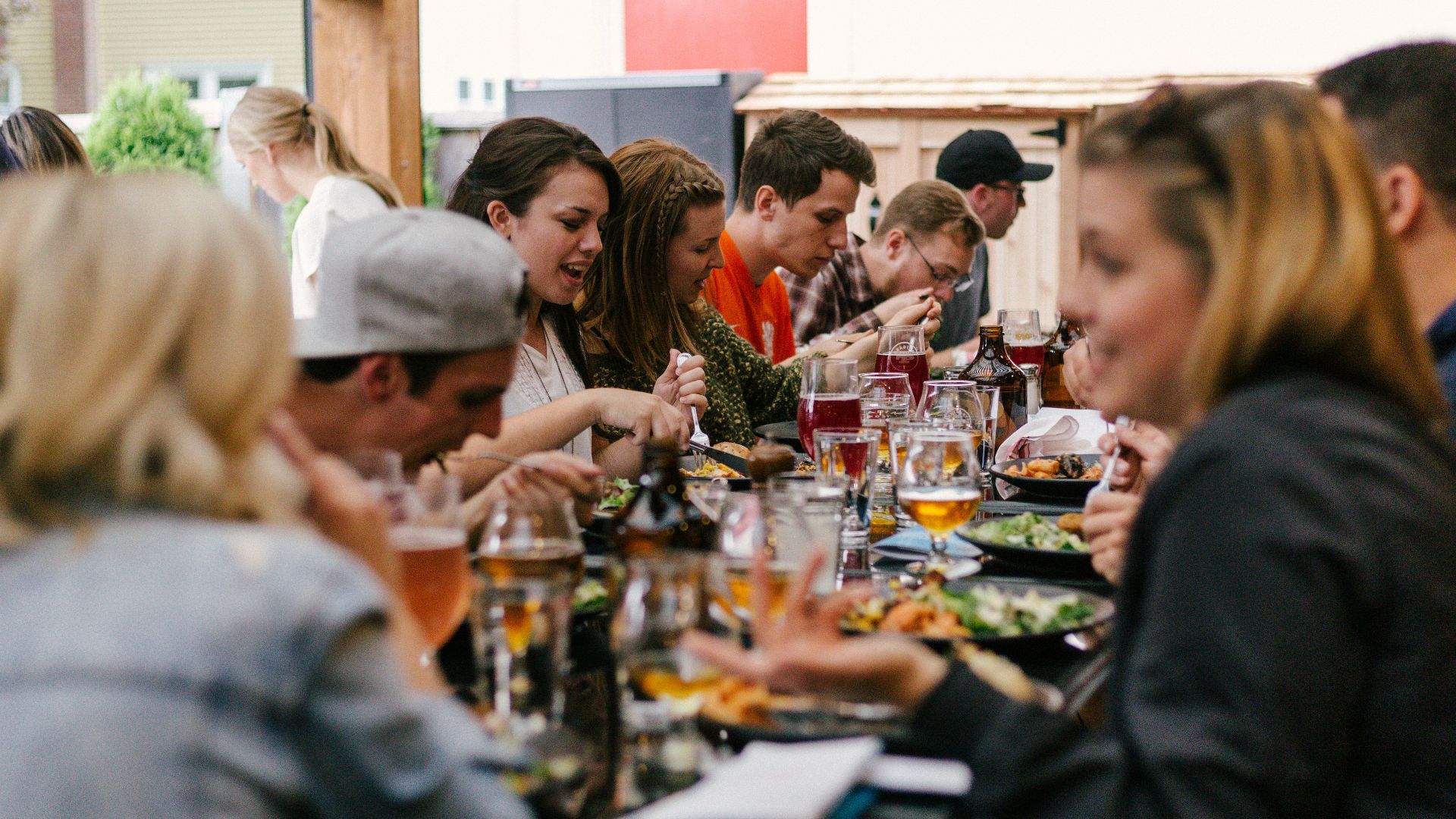 people sitting in front of table talking and eating