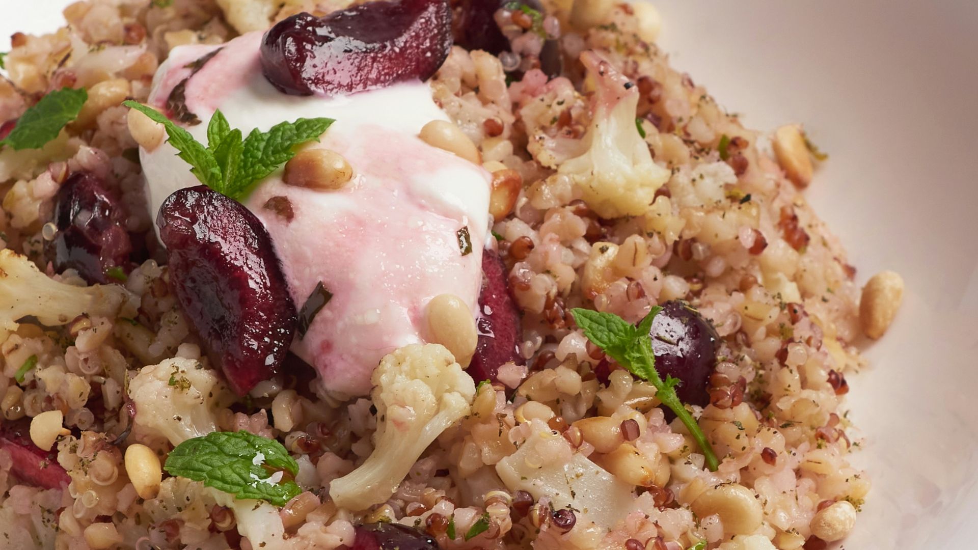 a white bowl filled with food on top of a table