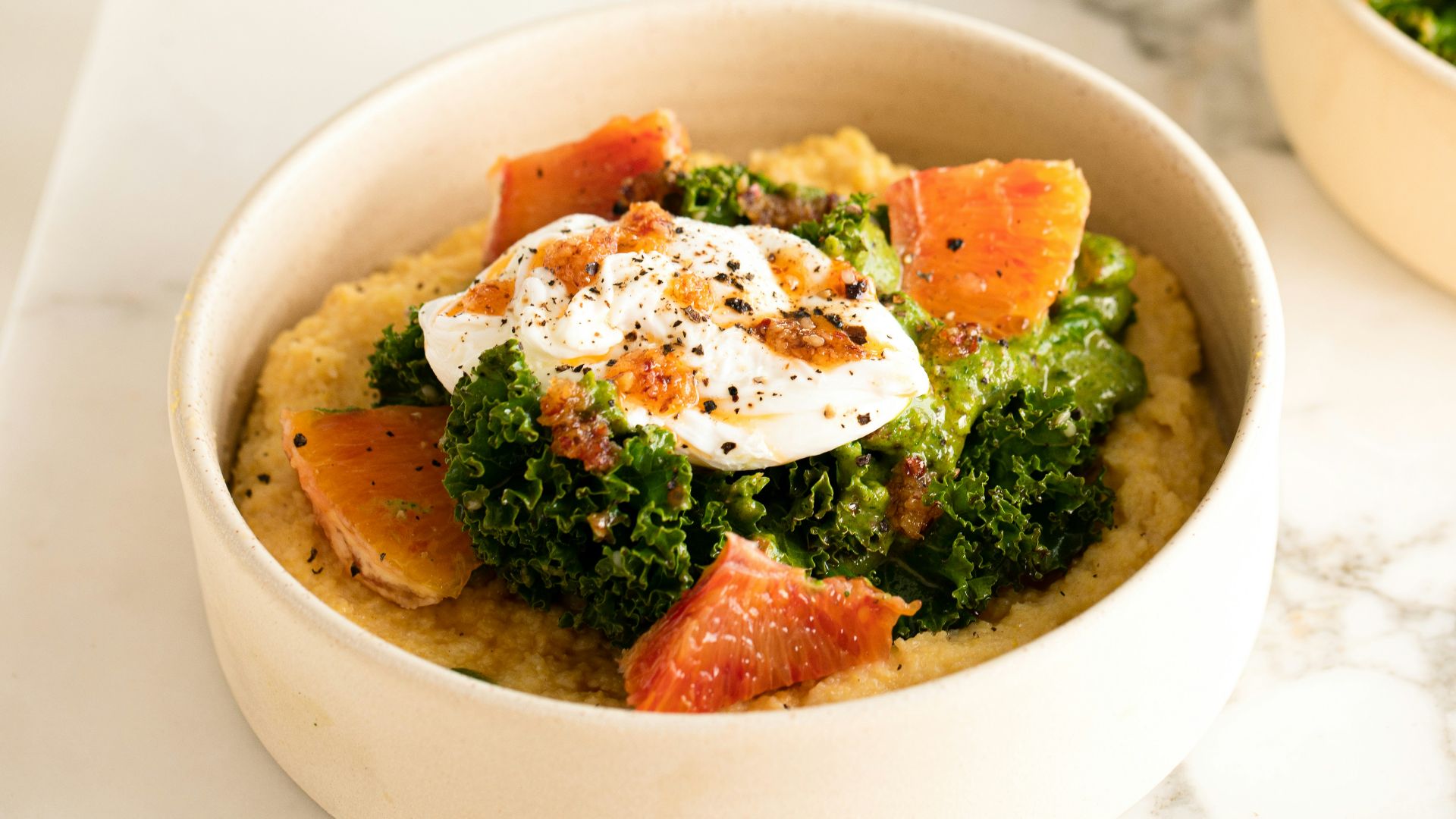 two bowls of food on a marble table