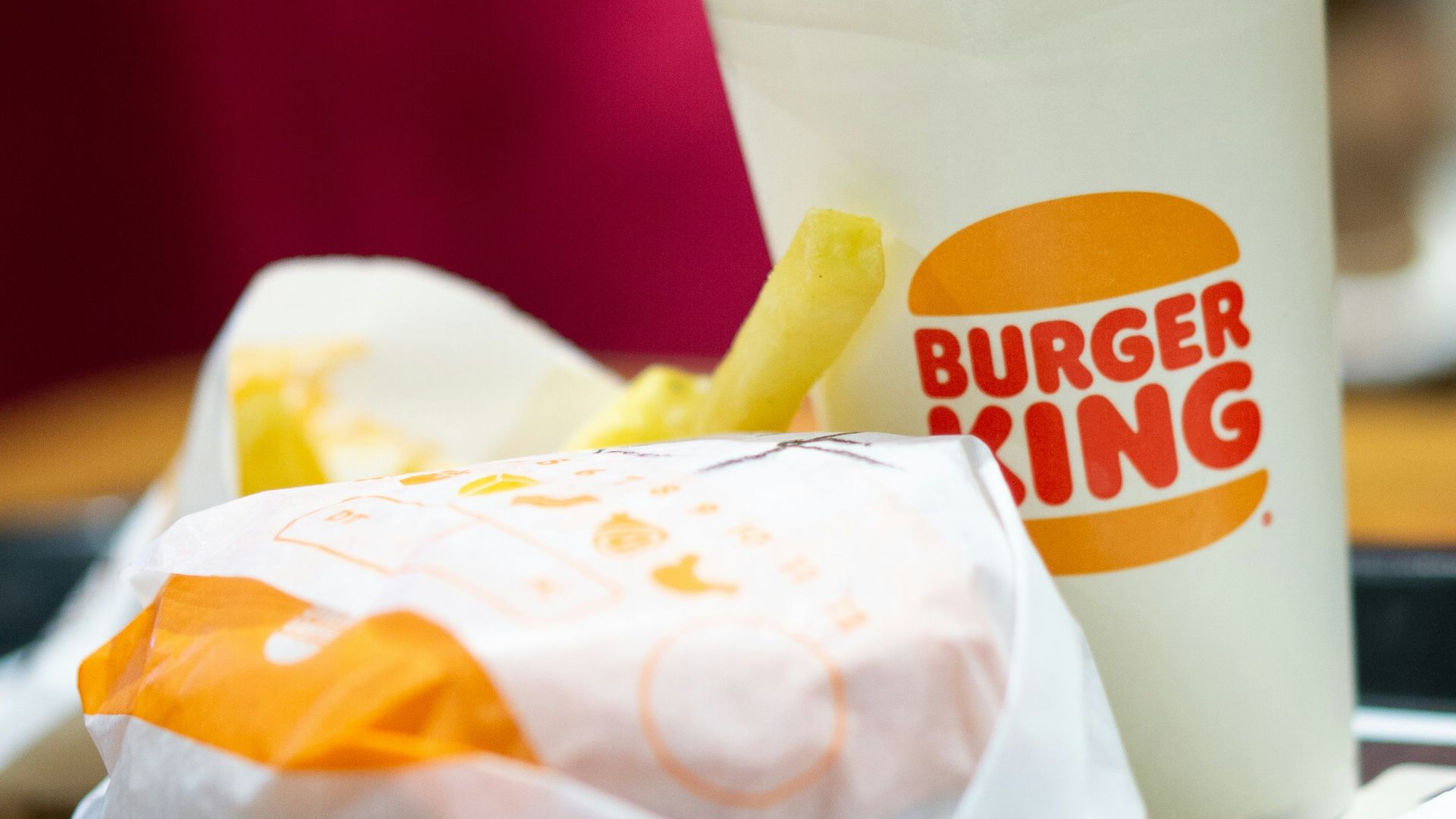 a burger king sandwich and a cup of coffee