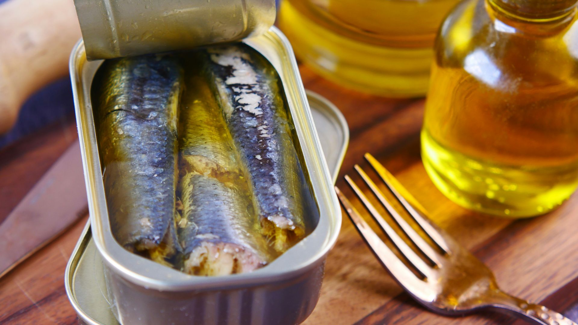 a tin of sardines sitting on top of a wooden table