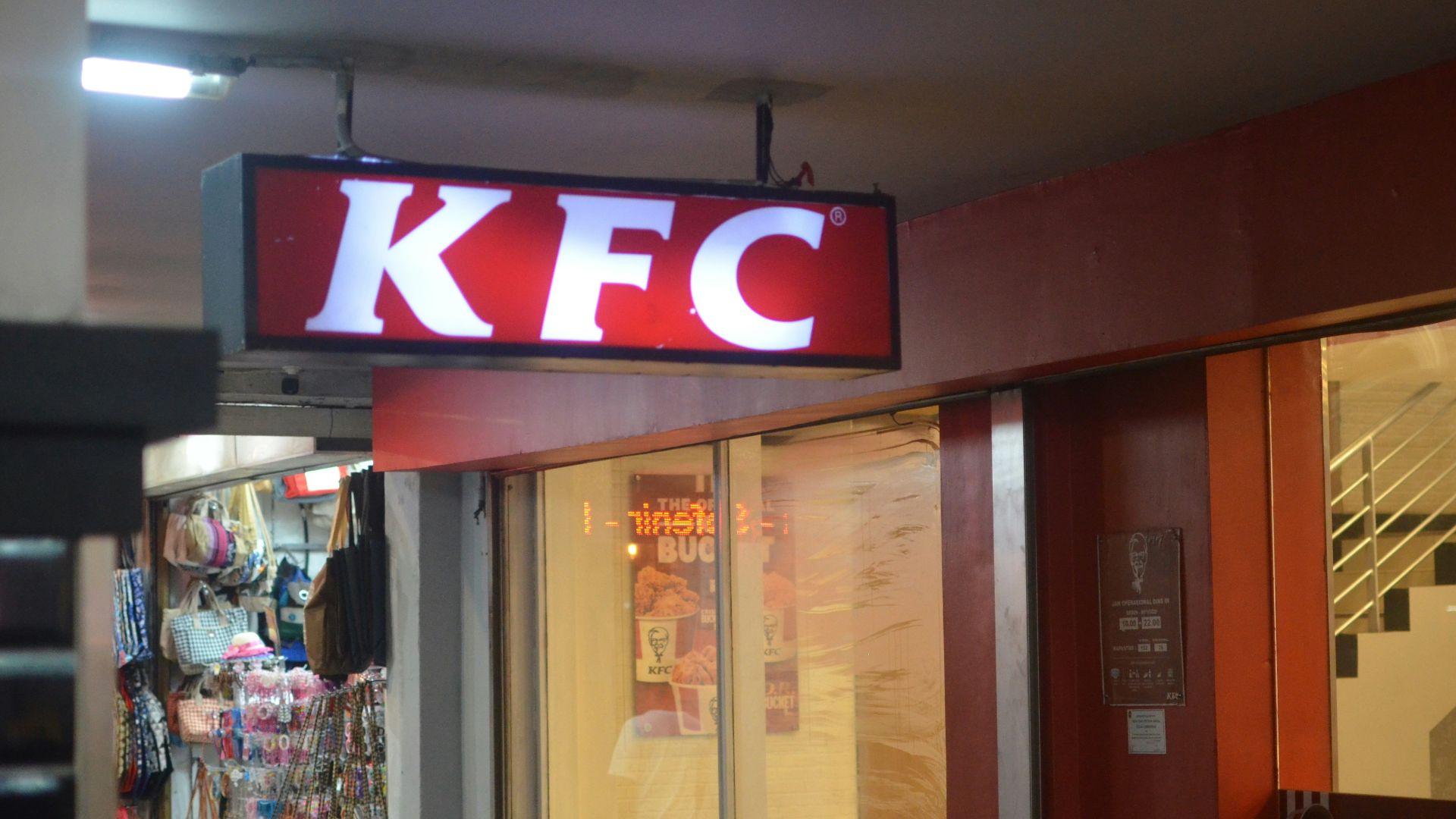a kfc sign hanging from the side of a building