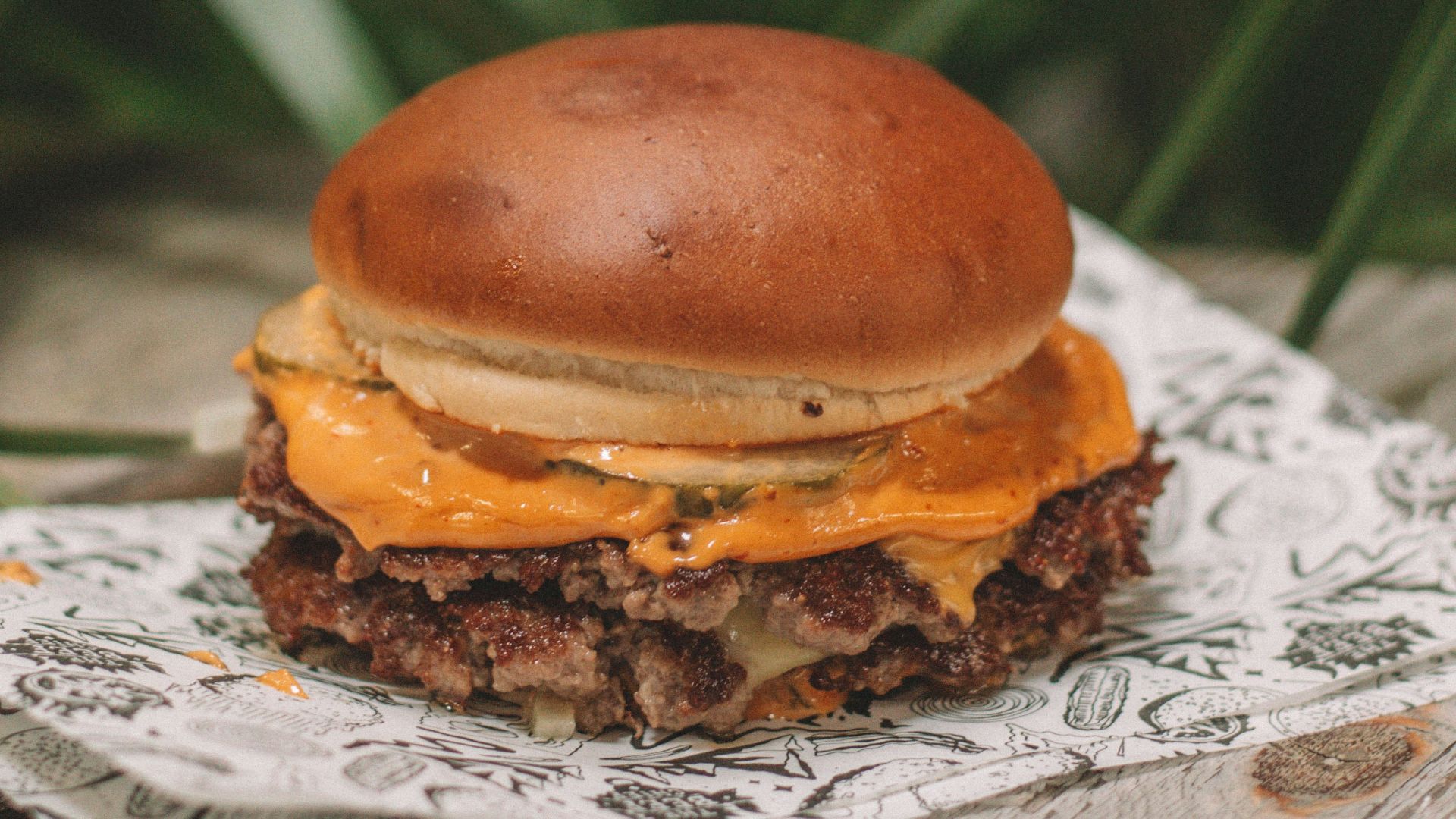 burger on white and red floral table cloth