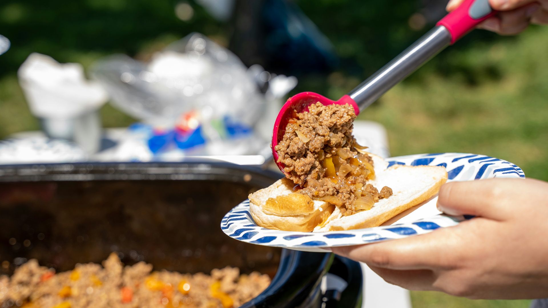 a person cutting a cake with a knife