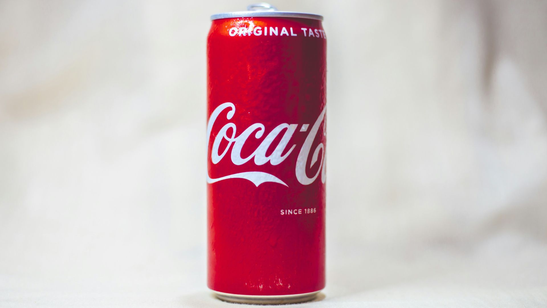 coca cola can on white table
