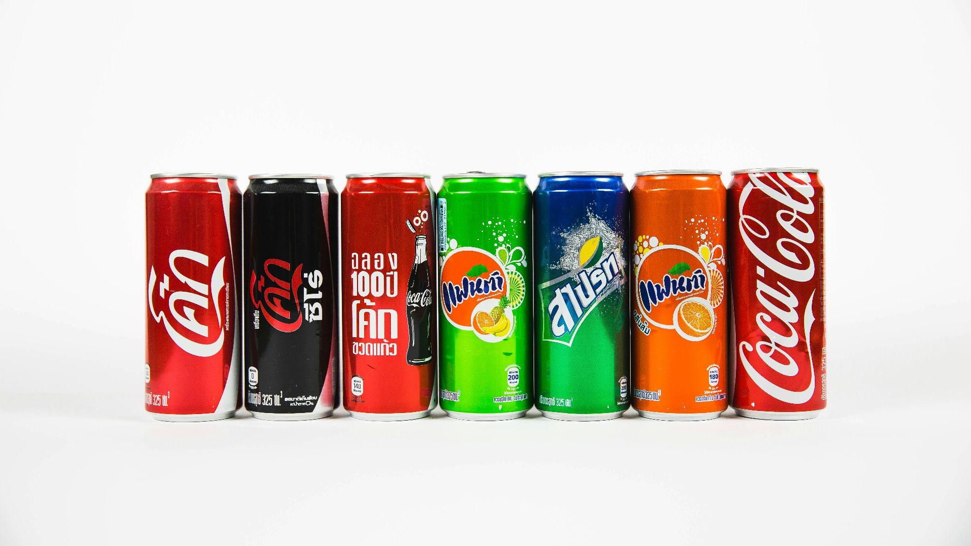 seven assorted-brand soda cans