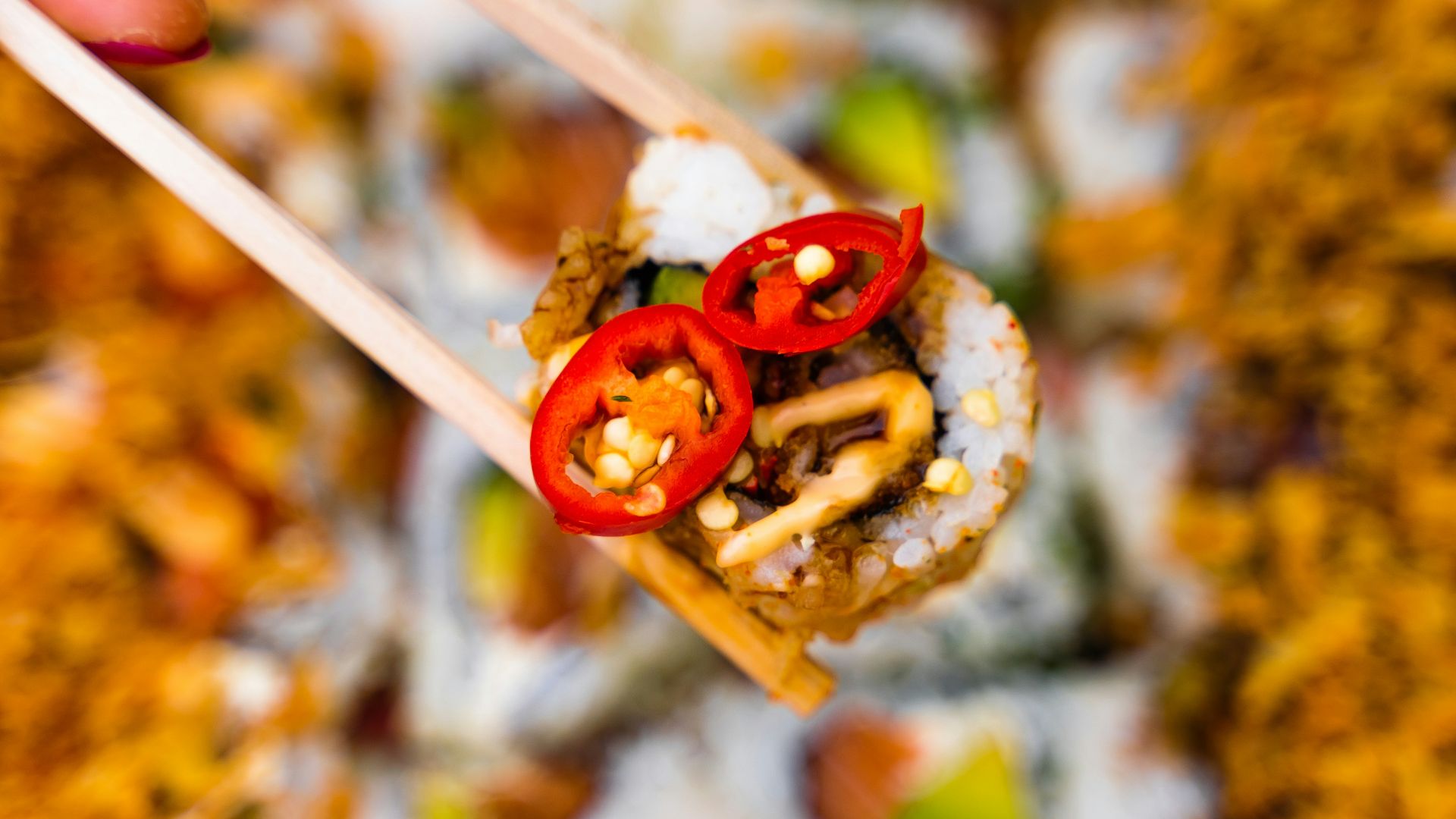 a person holding a chopstick with food on it