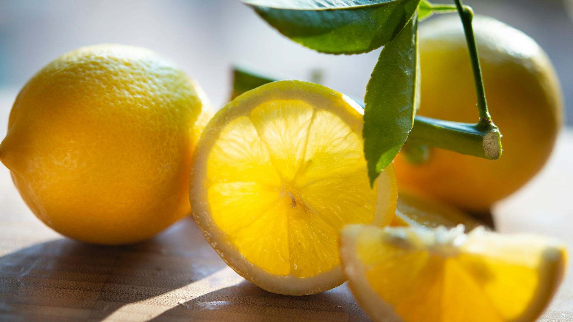 yellow lemon fruit on brown wooden table