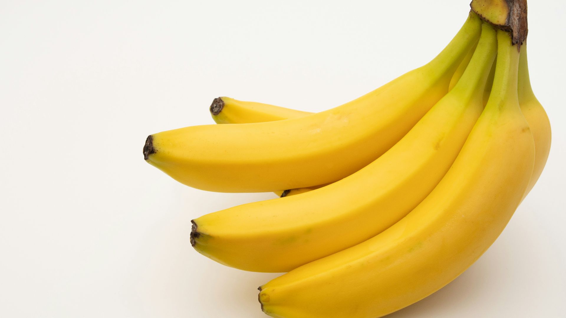 a bunch of bananas sitting on top of a white table