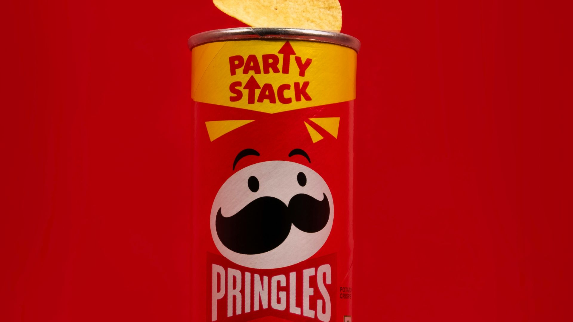 a can of pringles on a red background
