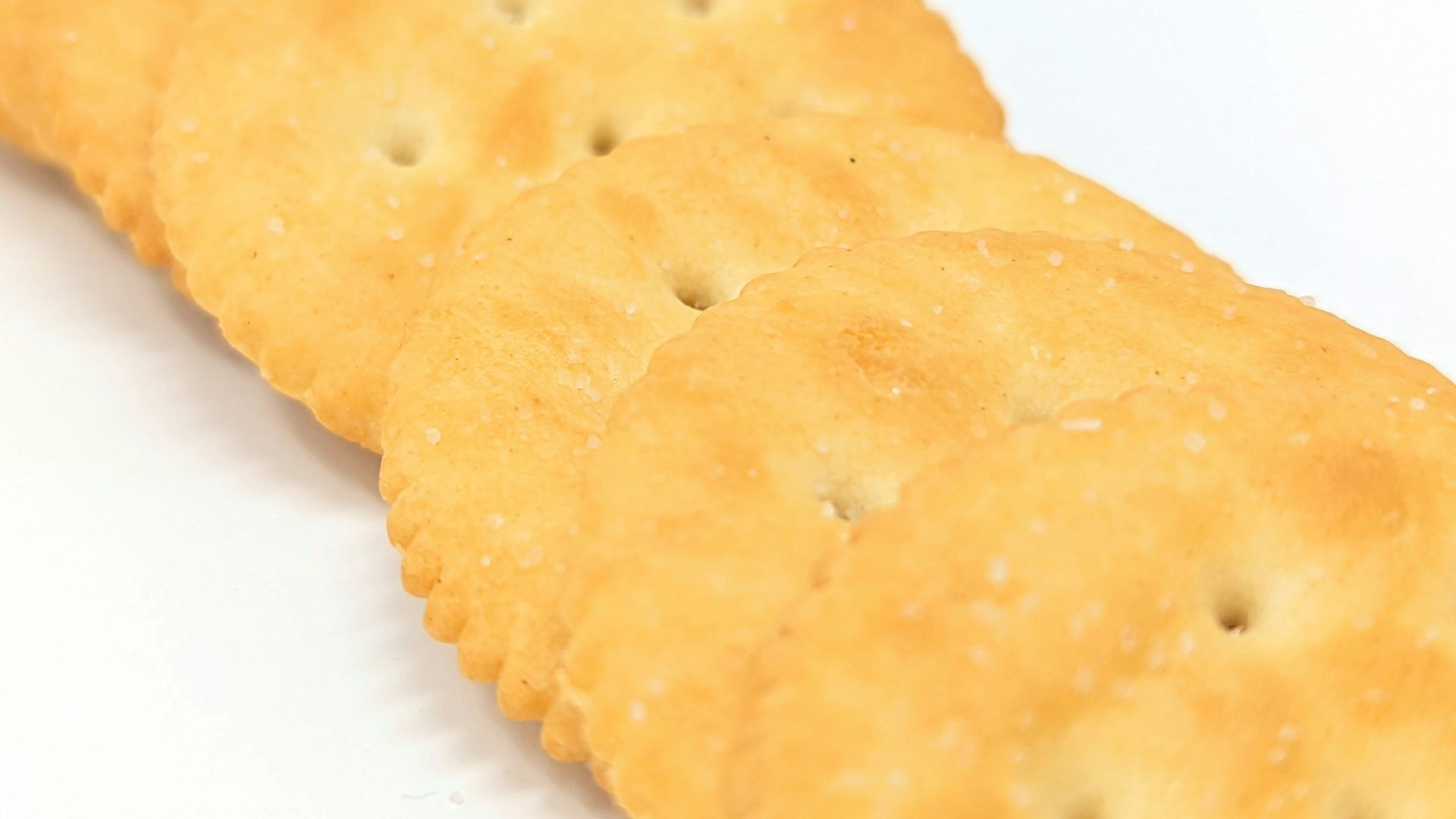 a close up of a cracker on a white surface