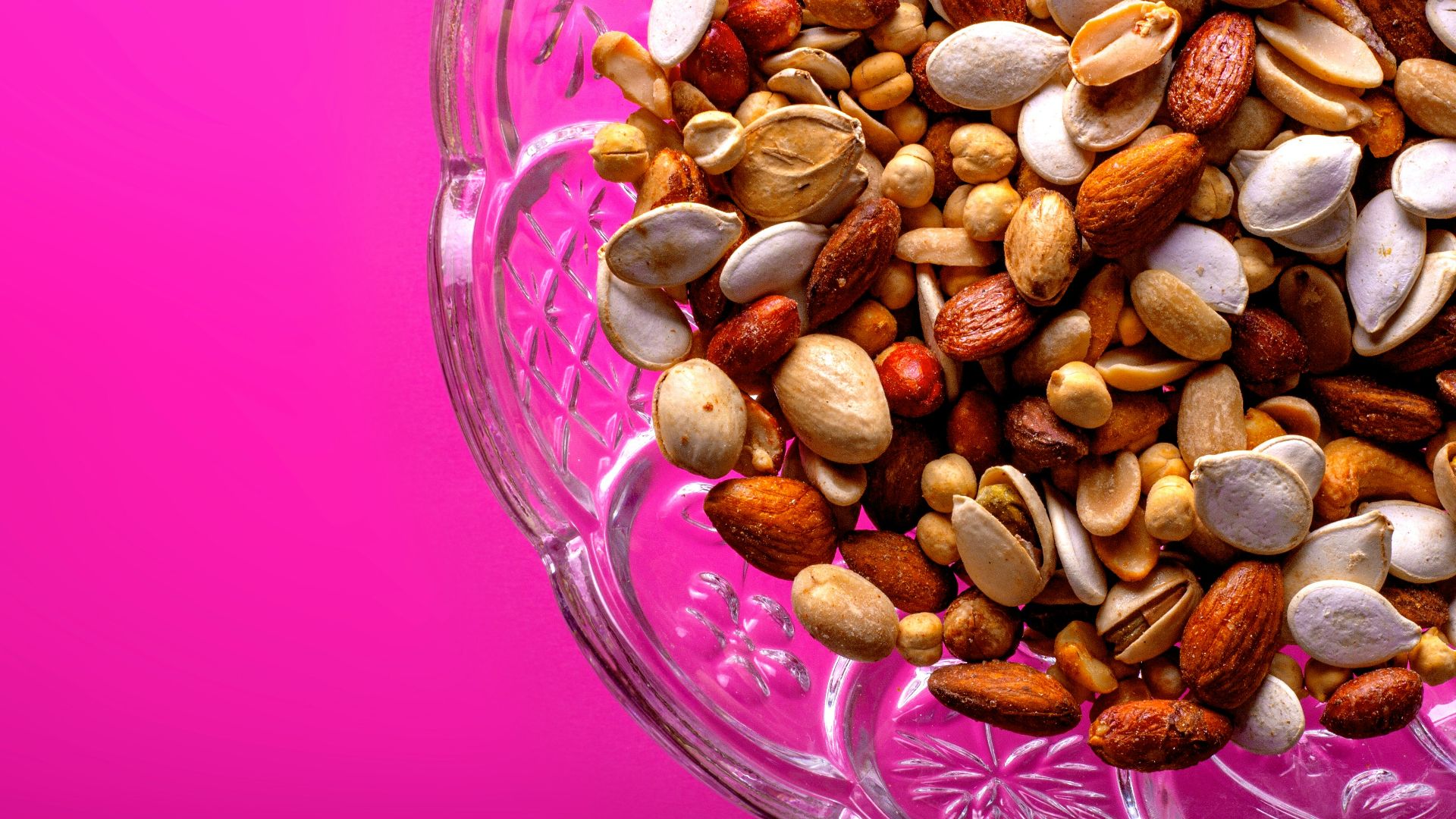 brown almond nuts on clear glass bowl