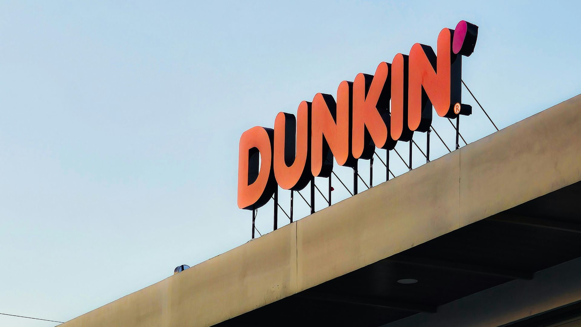 a dunkin'donuts sign on top of a building