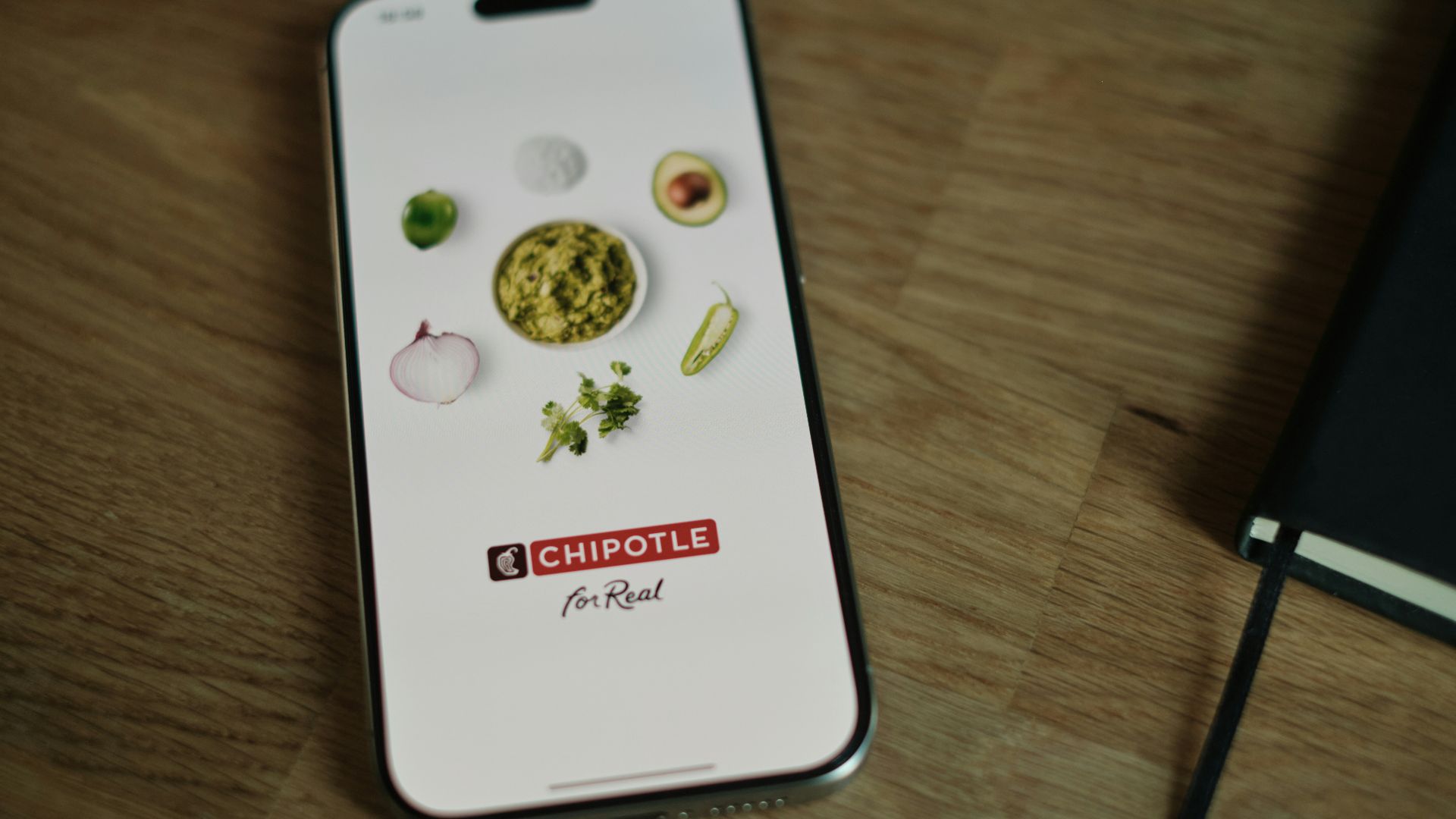 A cell phone sitting on top of a wooden table
