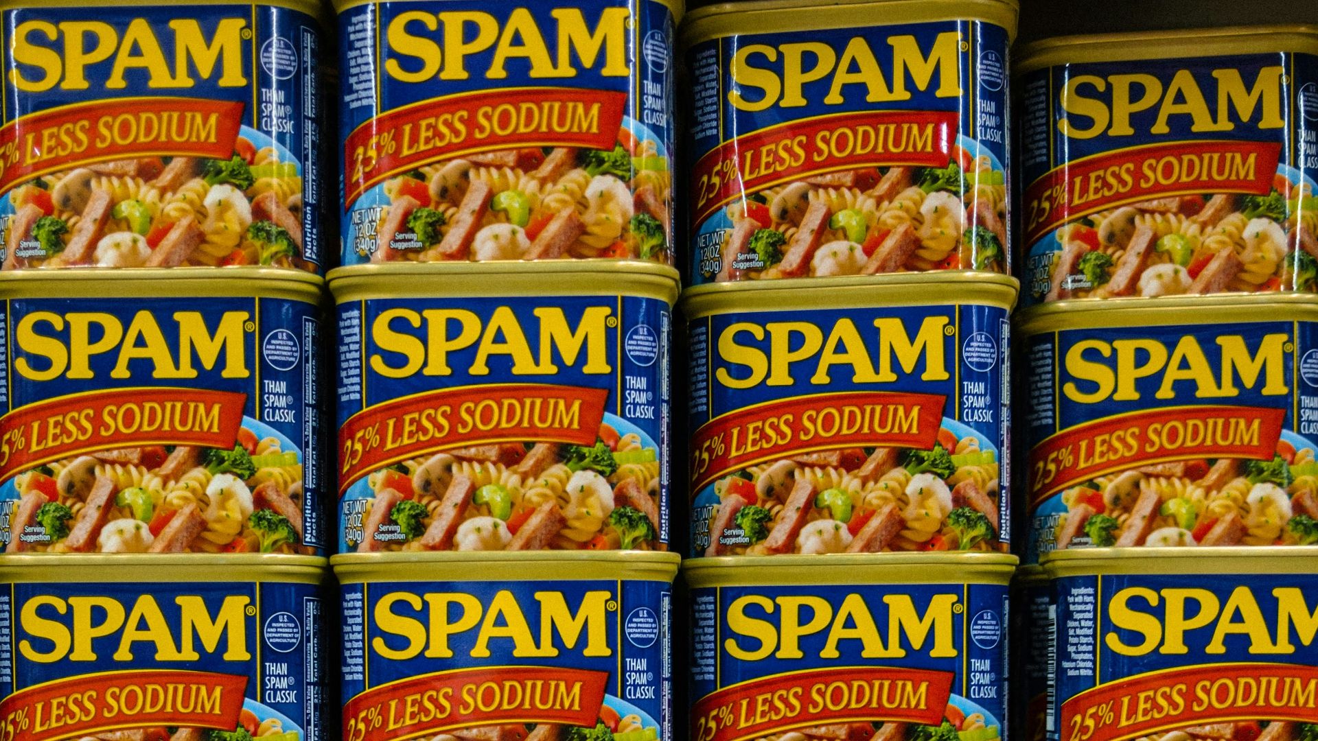 cans of spam are stacked on a shelf