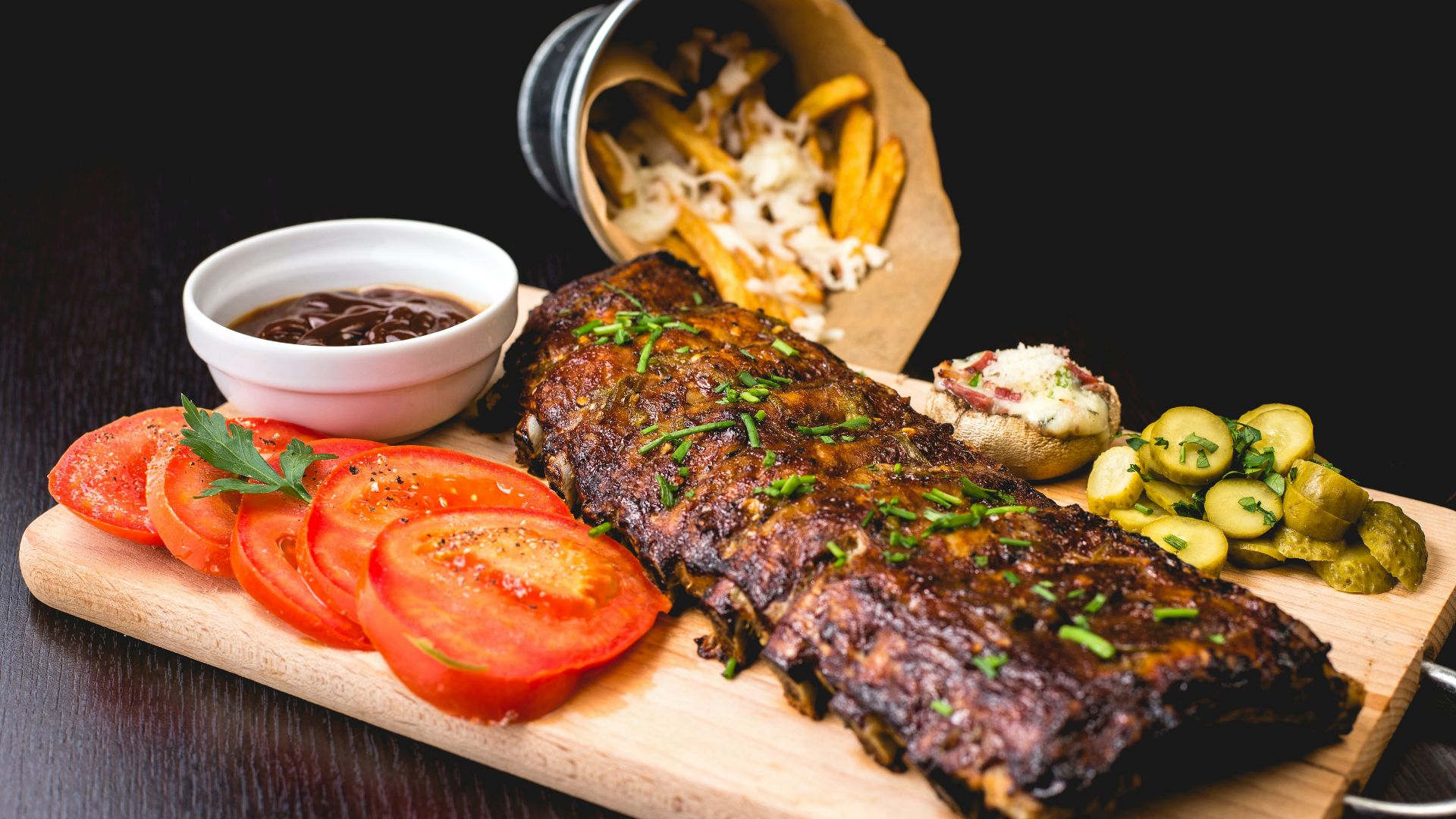 roasted ribs with sliced tomatoes and potatoes
