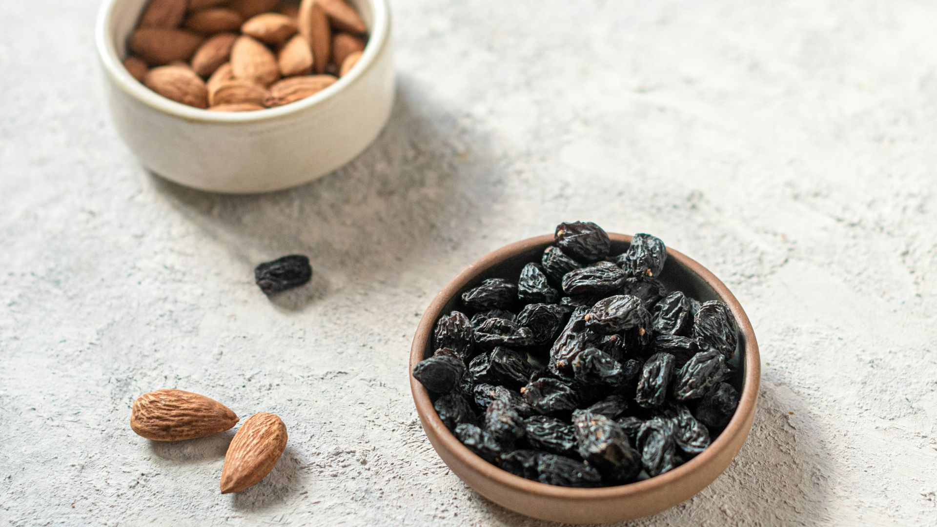 brown and black coffee beans on white ceramic bowl