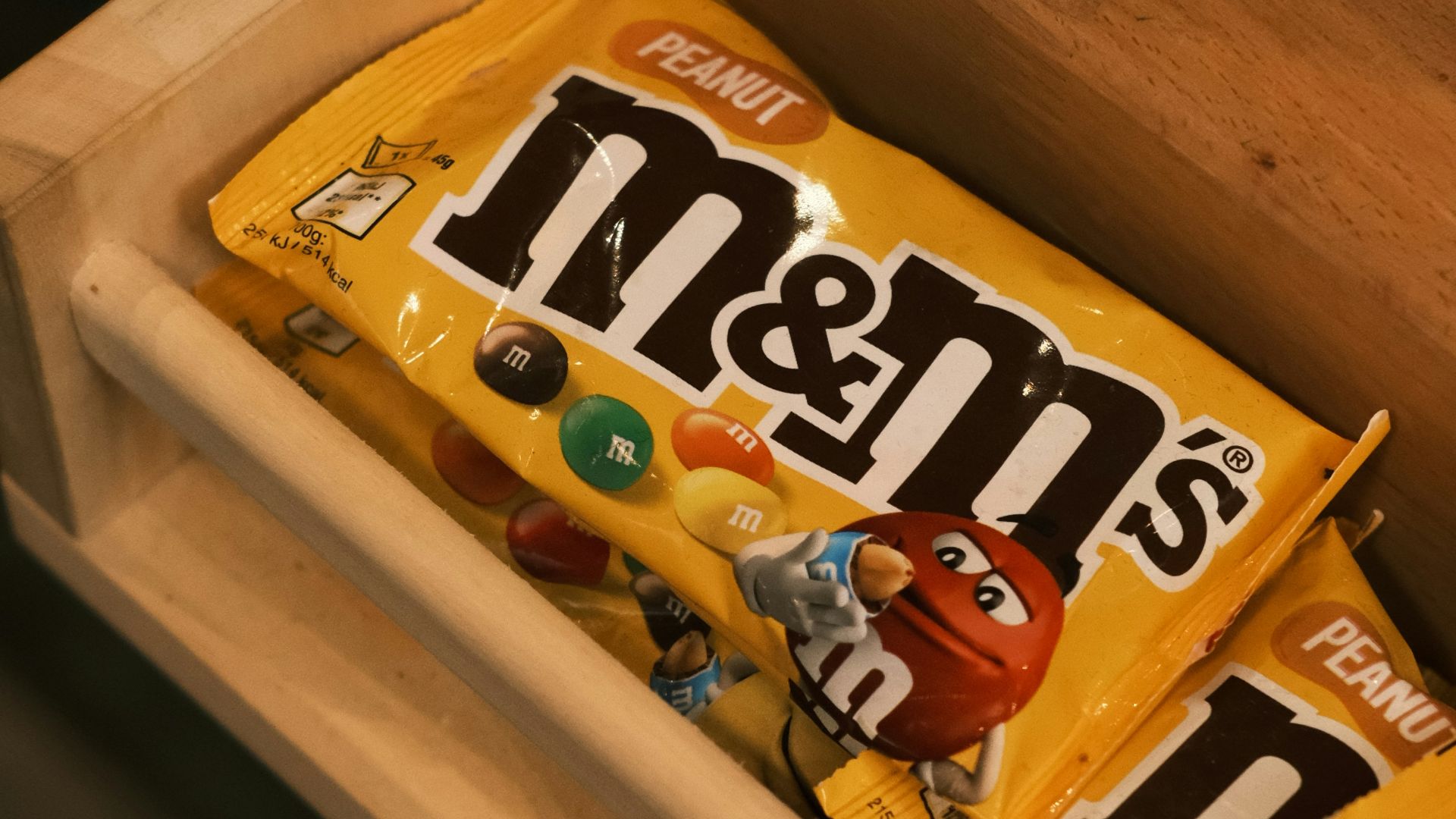 A box of m & m's is sitting on a table
