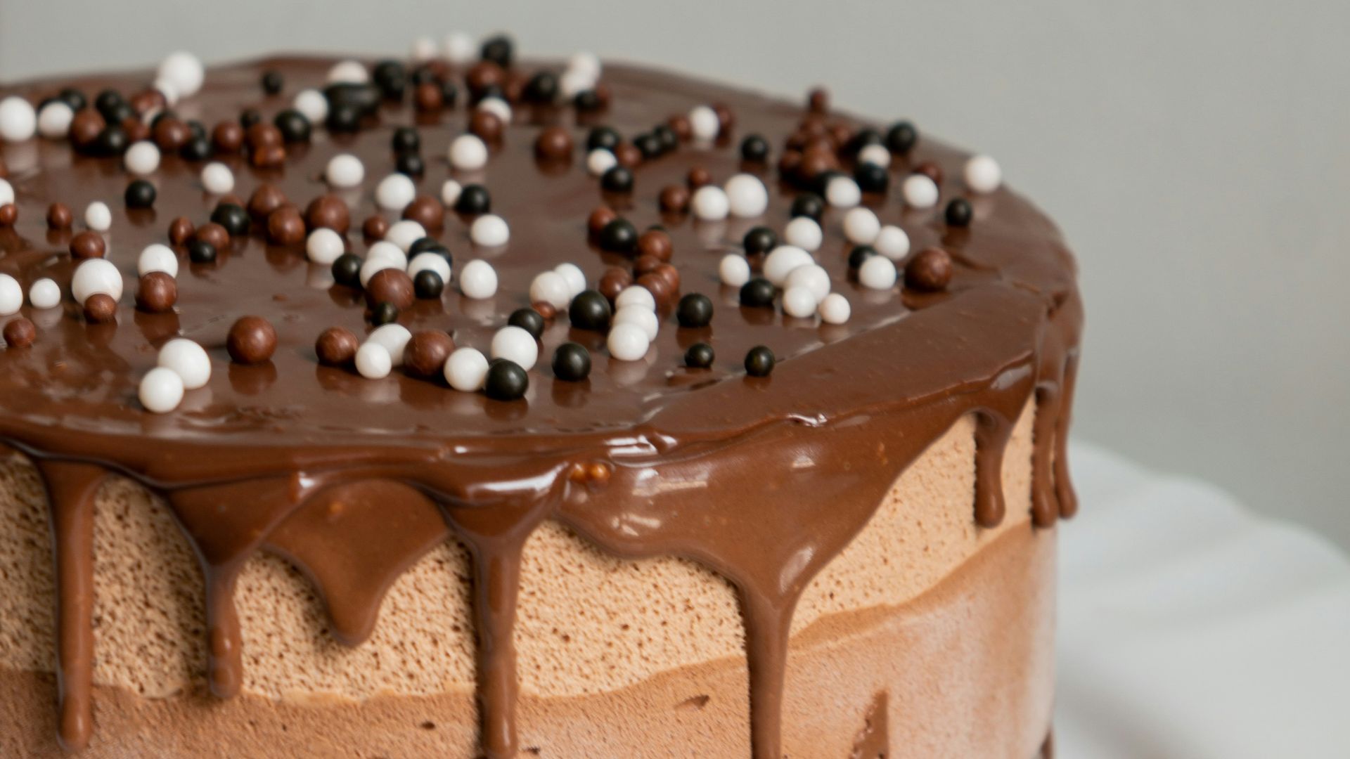 chocolate cake with white icing on white ceramic plate