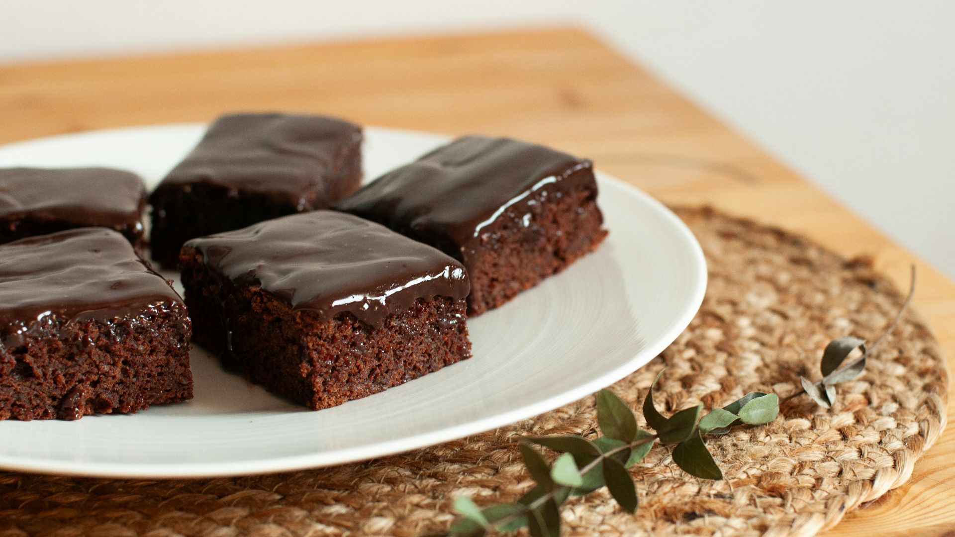 a white plate topped with brownies on top of a wooden table