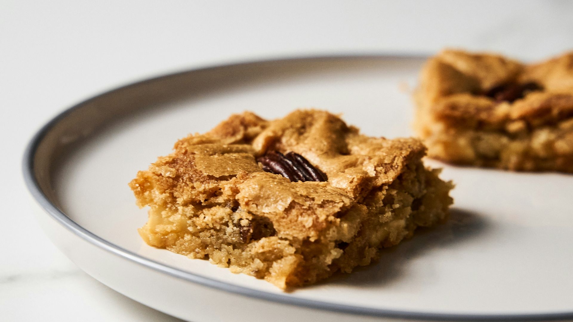 a white plate topped with two pieces of food